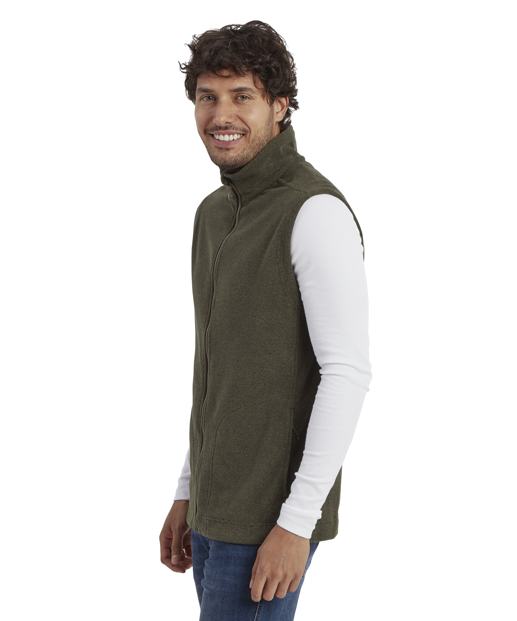 A side view of the man showcasing the slim fit and structure of the Sherpa Adventure Gear Rolpa Eco Vest in Green. The high collar and zipped front add a neat, functional touch. The man is smiling warmly while looking slightly over his shoulder.