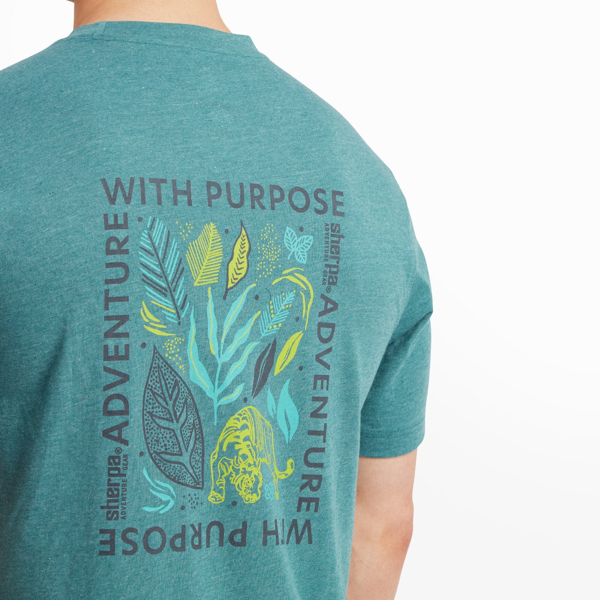 A detailed view of the back graphic highlights the intricate artwork, including vivid shades of green and yellow, the tiger illustration, and the surrounding text, emphasising the Sherpa Adventure Gear Purpose T-Shirt in Blue's connection to nature and exploration.