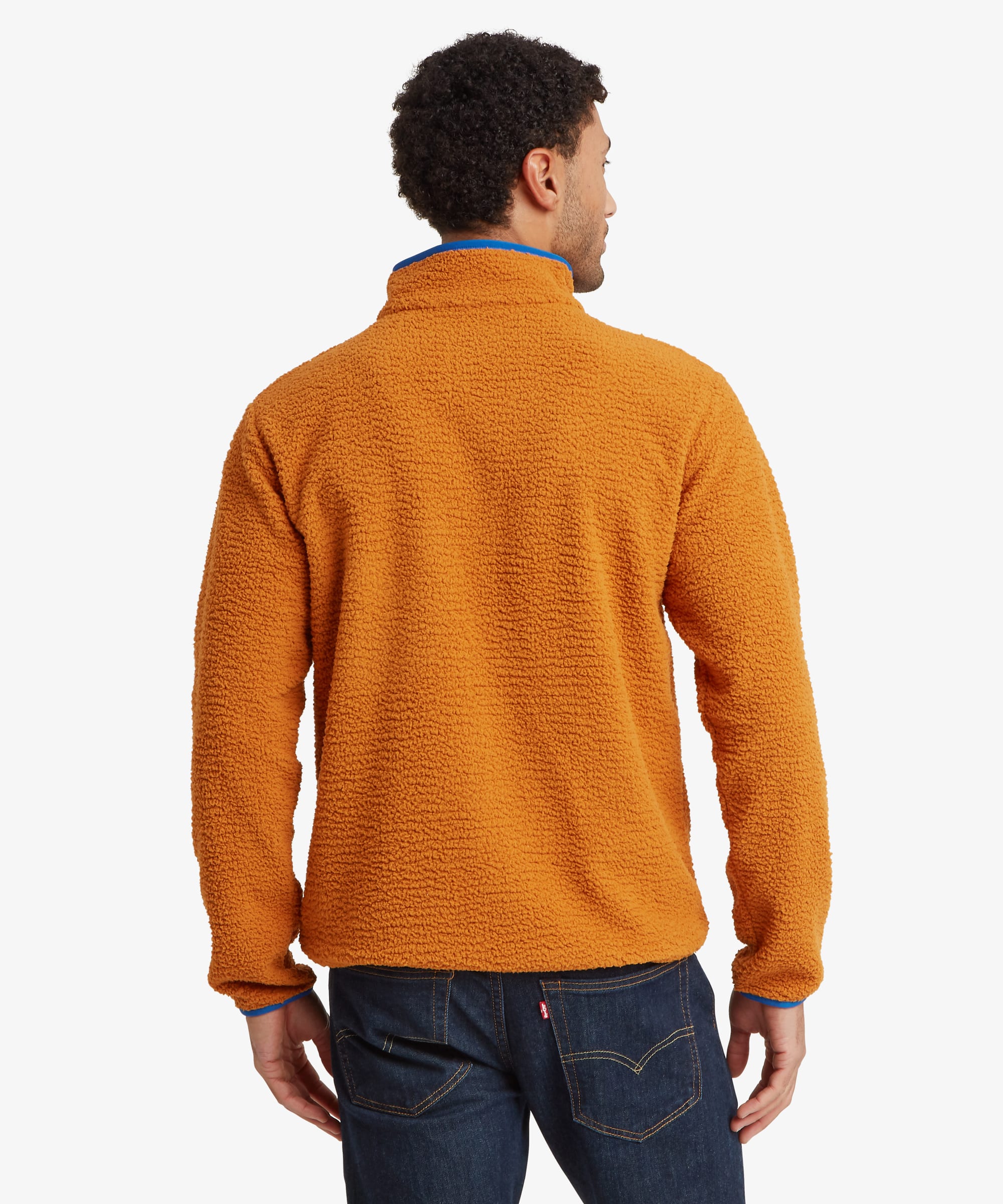 Back view of an orange fleece jacket displaying the clean rear panel, high collar, and plush sherpa fleece construction.