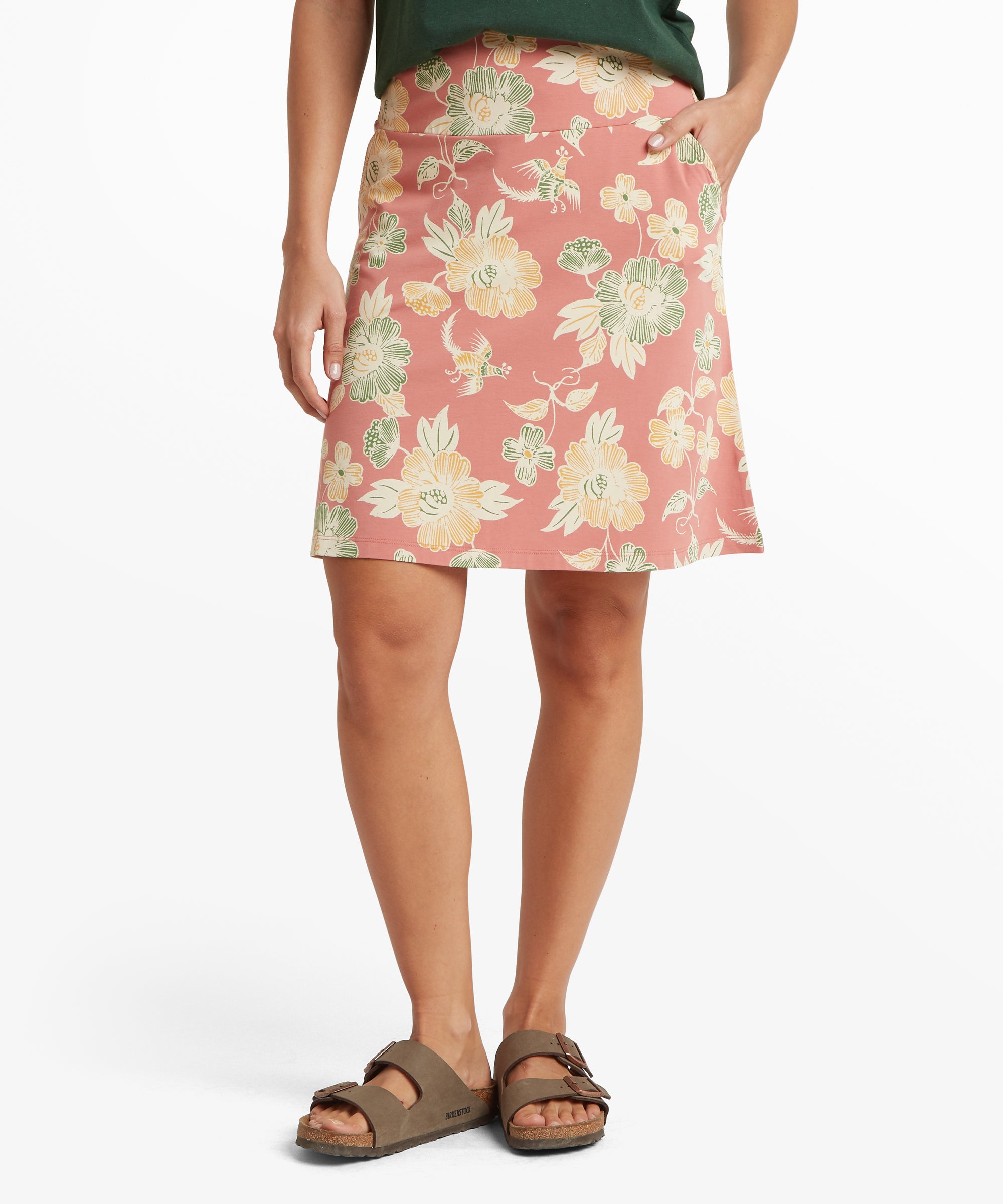 Person wearing a floral skirt on a white background