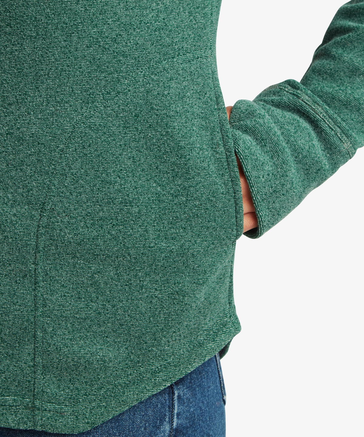 Close-up detail of the teal green Sherpa Rolpa Pullover showing the side seam pocket.