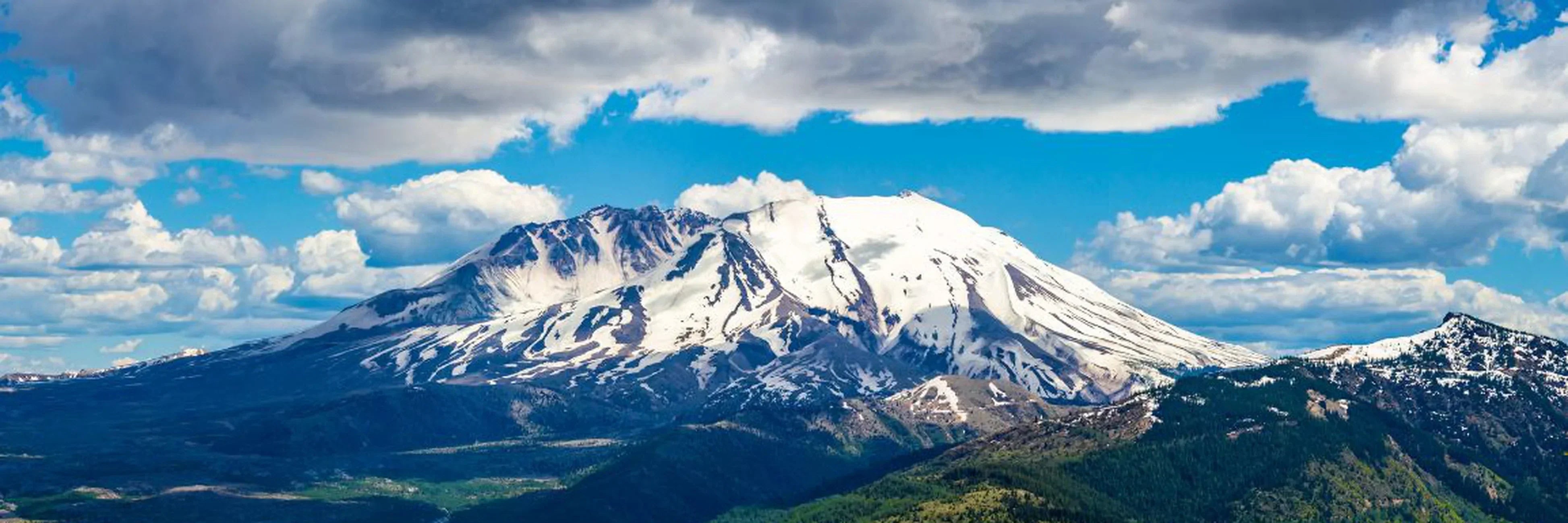 Snow-capped Cascade Range peaks with forests in national parks