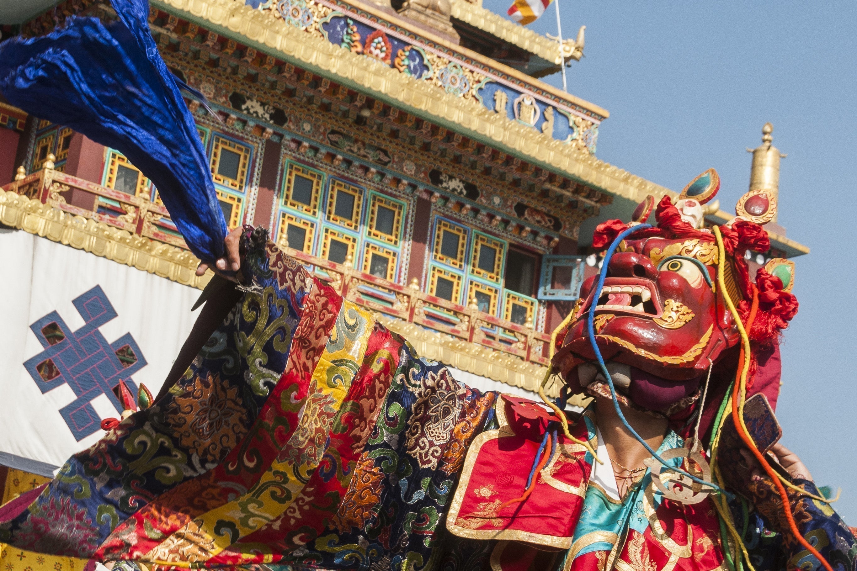 Vibrant red ceremonial mask with gold accents in Nepal festivals