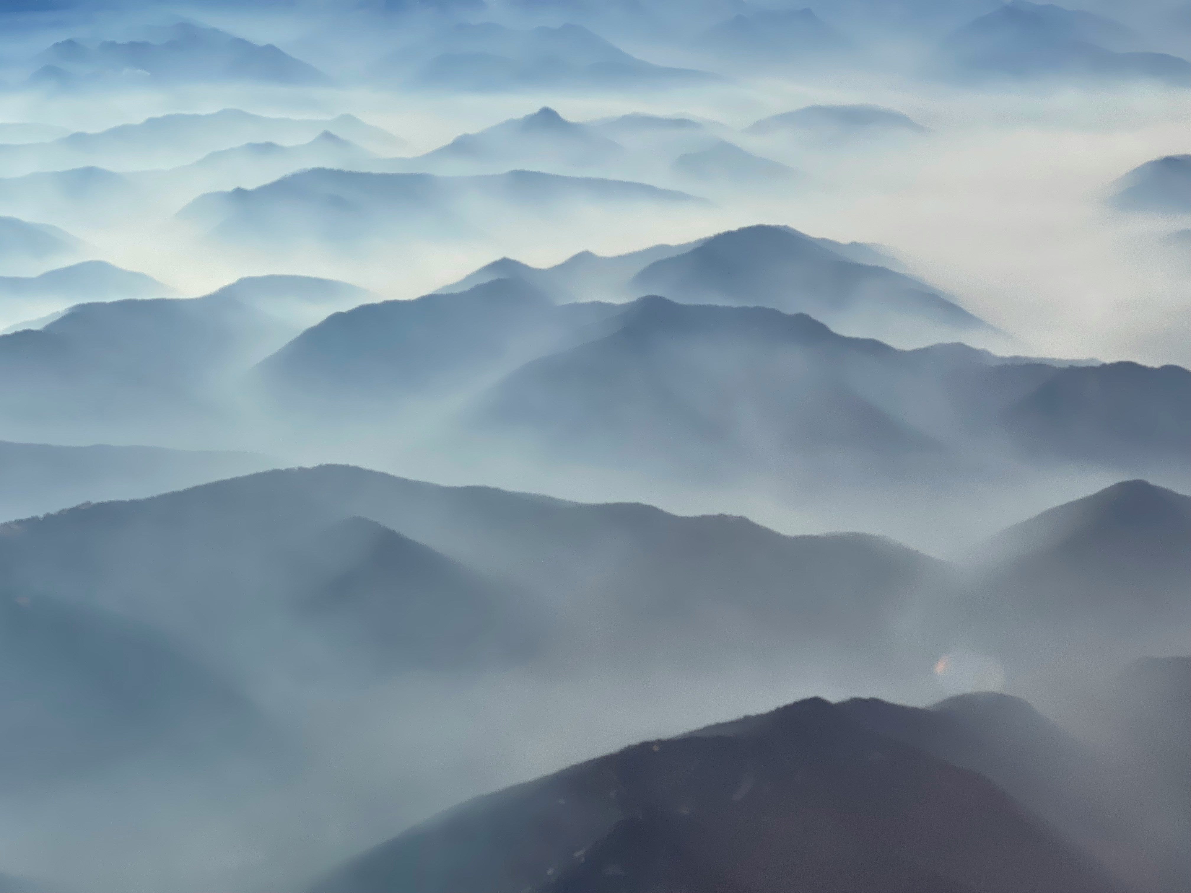 Layered Cascade Volcanic Arc ridges fade into misty blues and grays.
