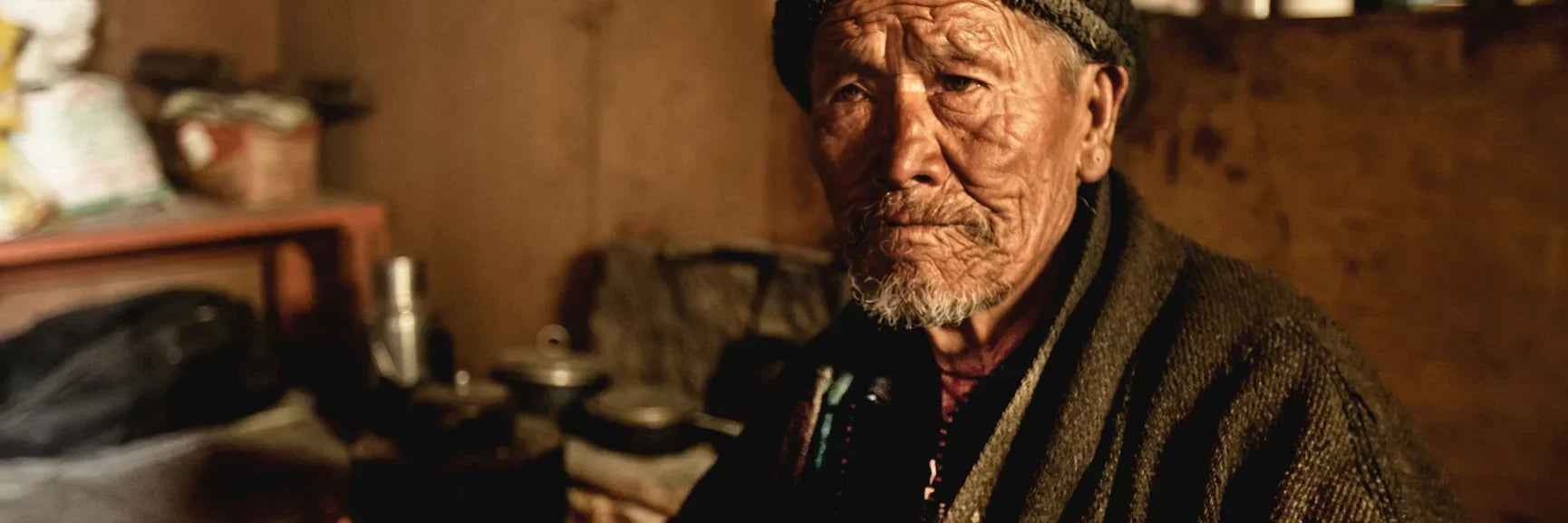 Elderly Sherpa man from Nepal with gray beard and woolen coat