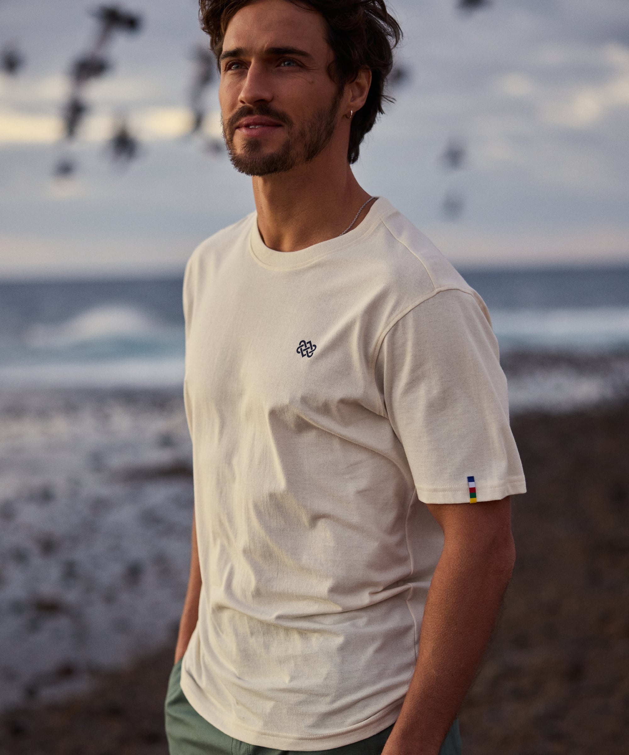 Jutnu Himalayan Peetho off-white crew-neck t-shirt with black logo and striped tag