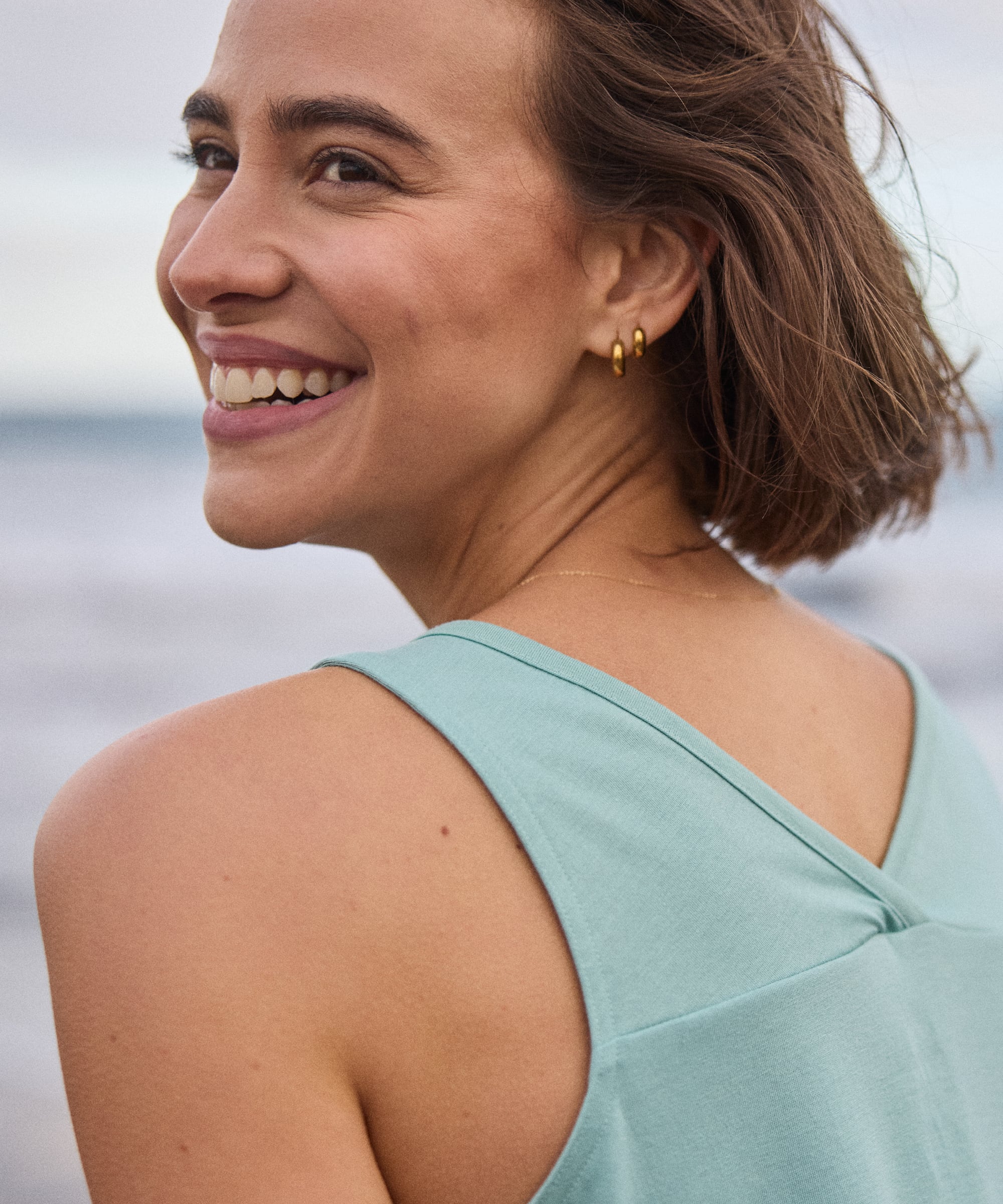Woman wearing Bali V-Neck Tank Top - Mist, light blue sleeveless top