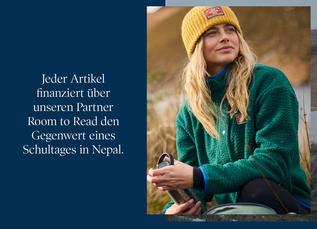Woman in yellow beanie and green fleece holding a thermos, with German Room to Read logo text.