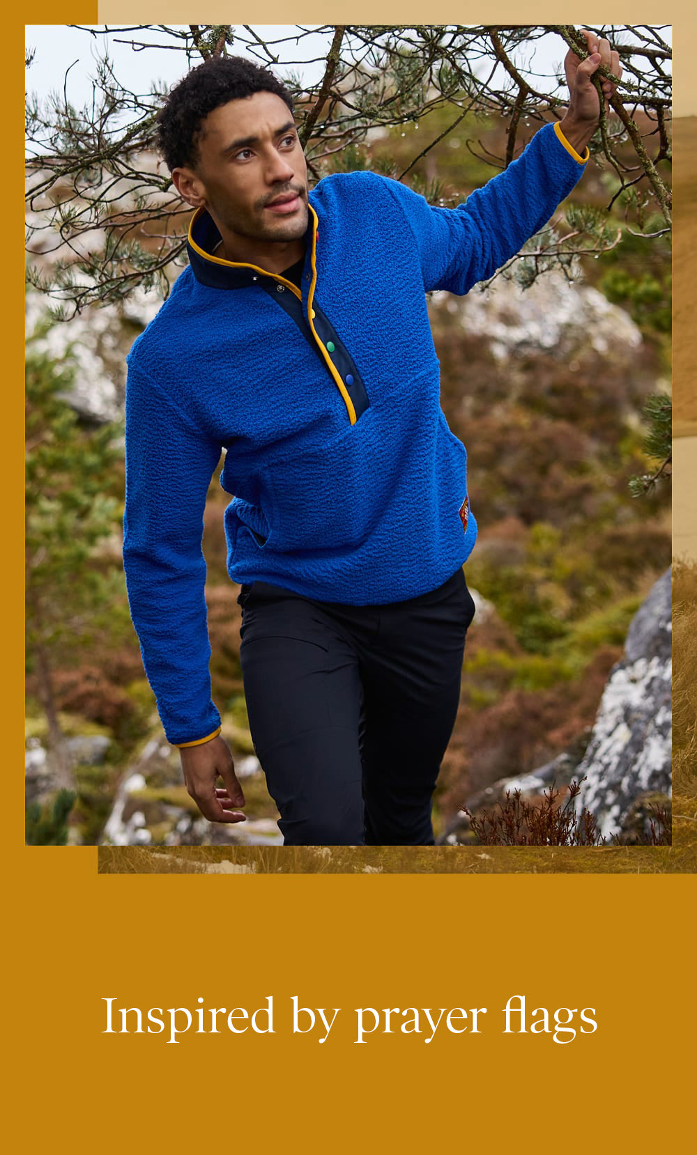 Man in a bright blue quarter-zip fleece with yellow and black trim, outdoors.