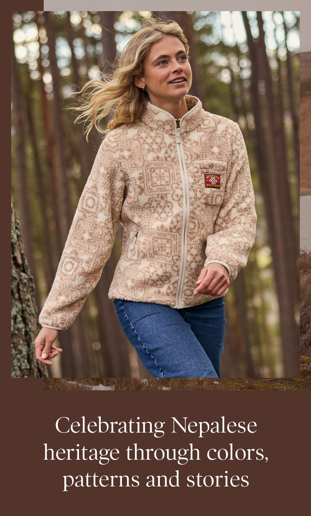 Woman in a beige patterned fleece and blue jeans strolling in a forest.