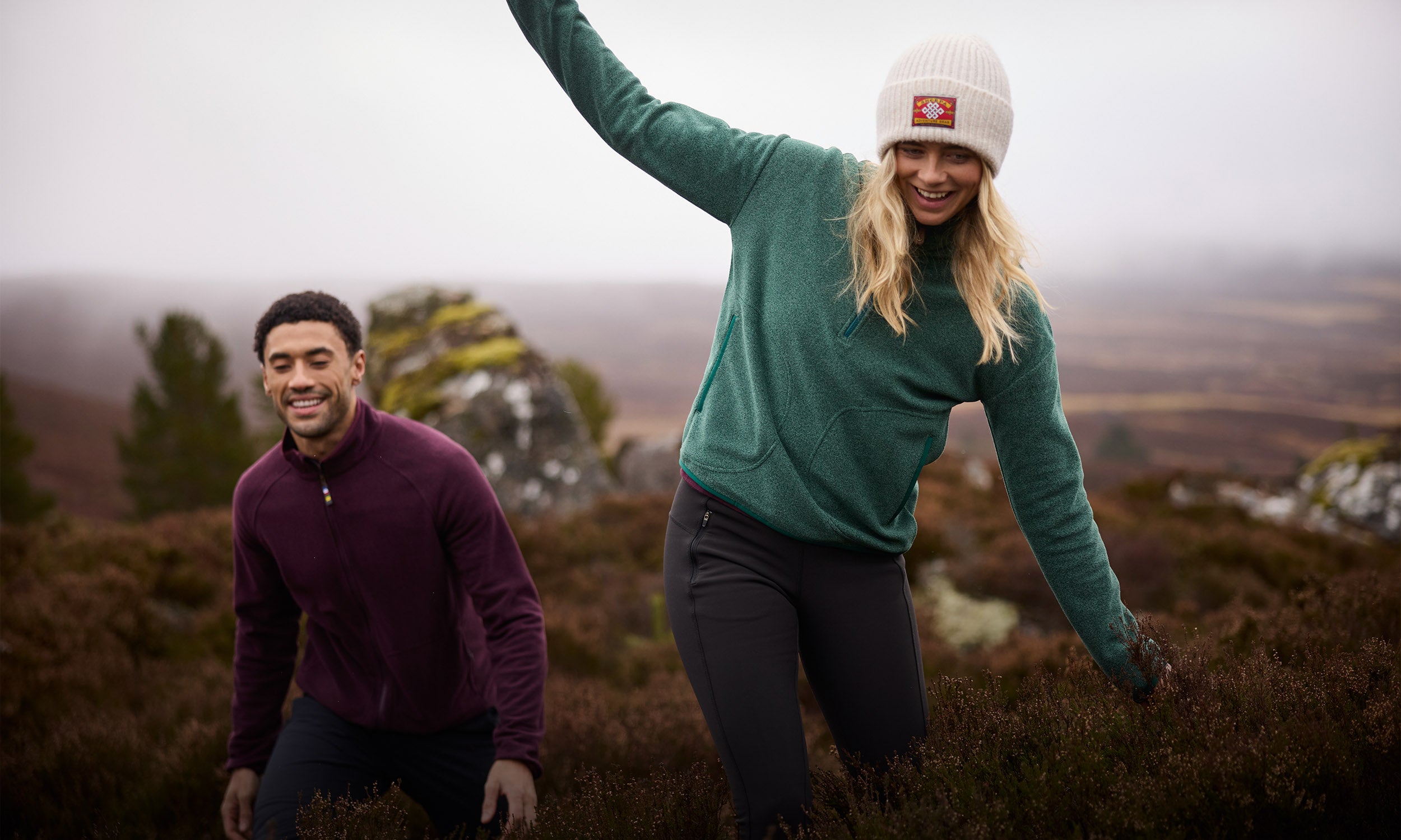 Couple hiking heather moorland in cosy knit fleece jumpers