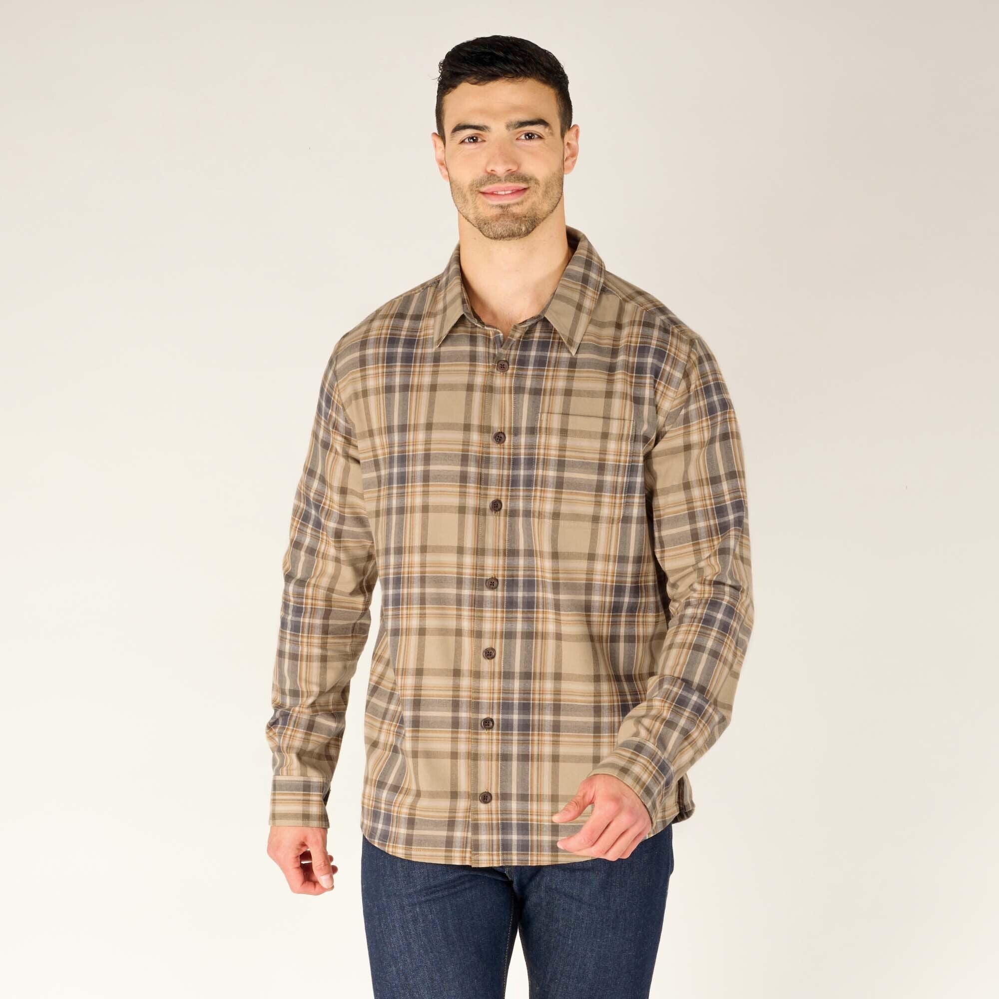 A front-facing view of the model with a neutral expression. The shirt is buttoned up, neatly fitted, and features a structured collar. The Sherpa Adventure Gear Rudra Shirt in Beige design consists of beige, brown, and subtle blue lines.