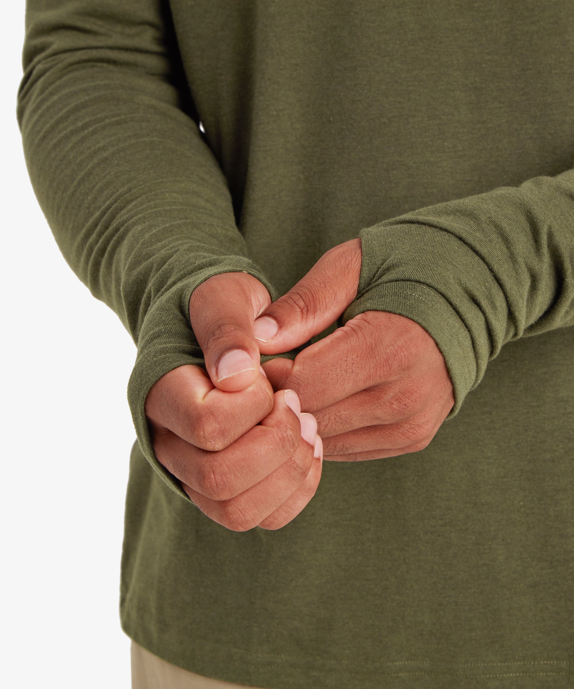 A close up of a man wearing a green hoodie. The cuffs and sleeves of the hoodie are visible. The cuffs feature thumb loops on both hands. The man is adjusting his right cuff.