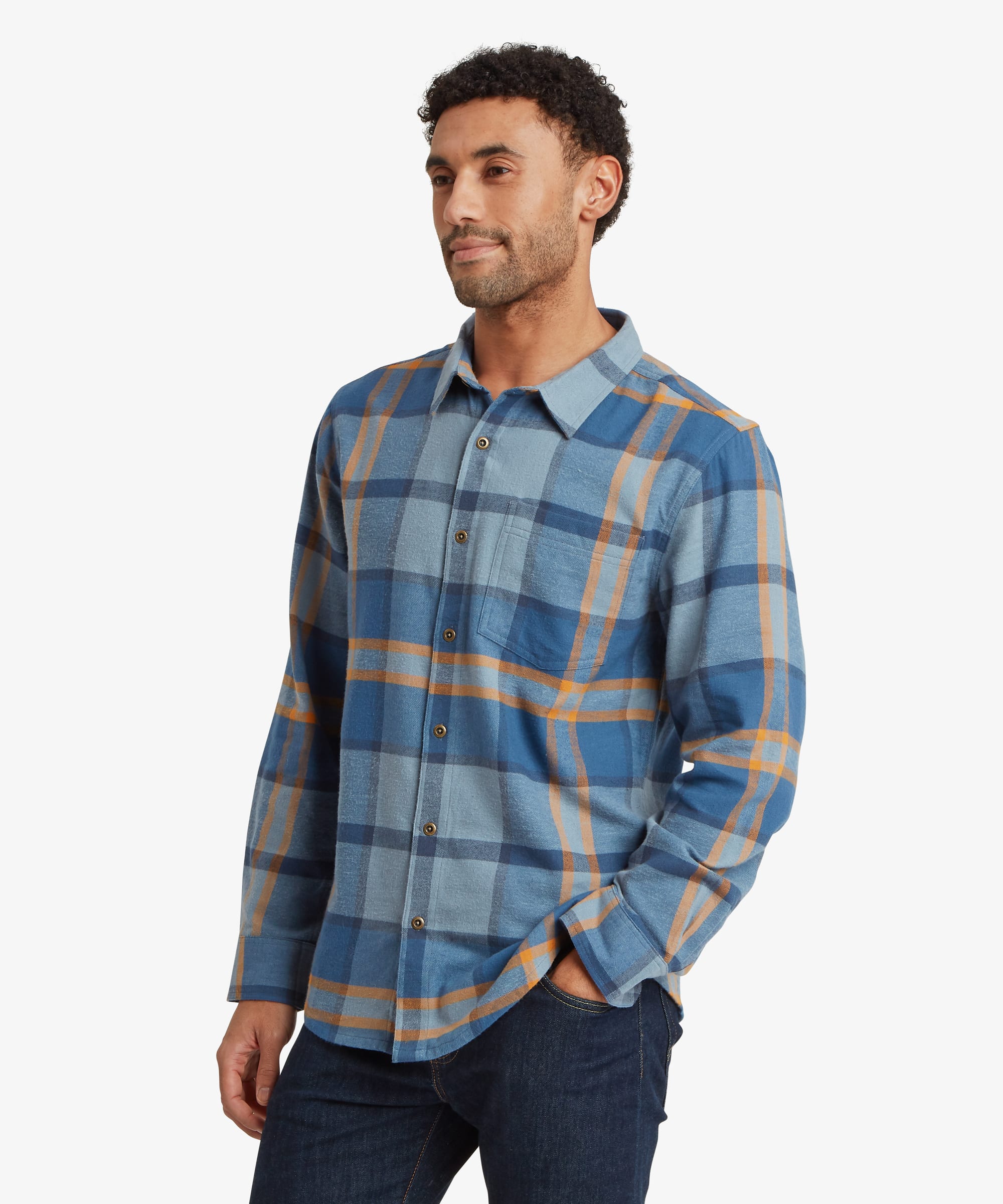 Front view of a man wearing a blue plaid long-sleeve shirt featuring a classic collar, button-front closure and chest pocket. The relaxed-fit shirt is paired with dark jeans for a casual everyday look.