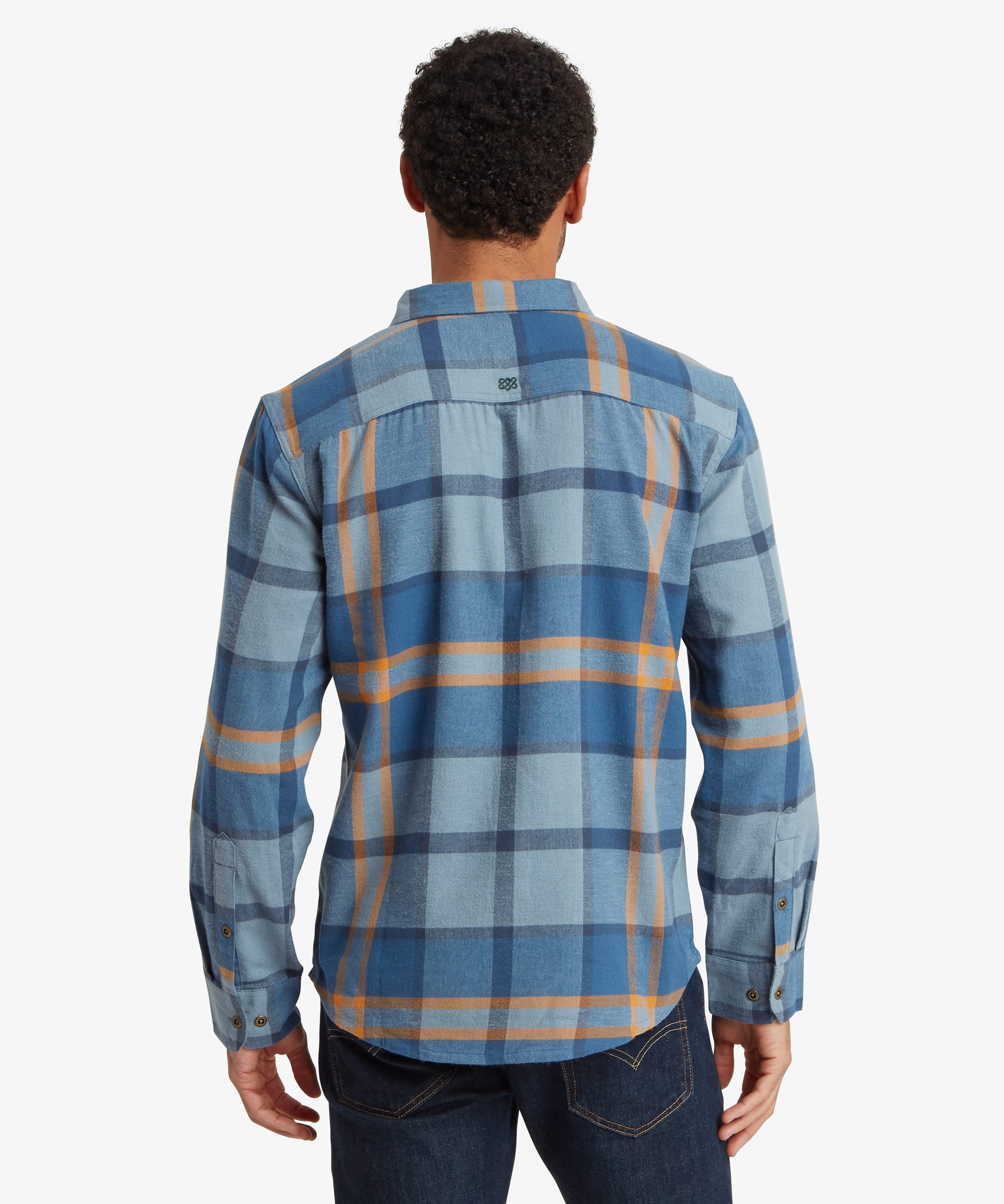 Back view of a blue plaid long-sleeve shirt featuring a large-scale check pattern in shades of blue, grey and mustard and a relaxed fit across the shoulders and back.