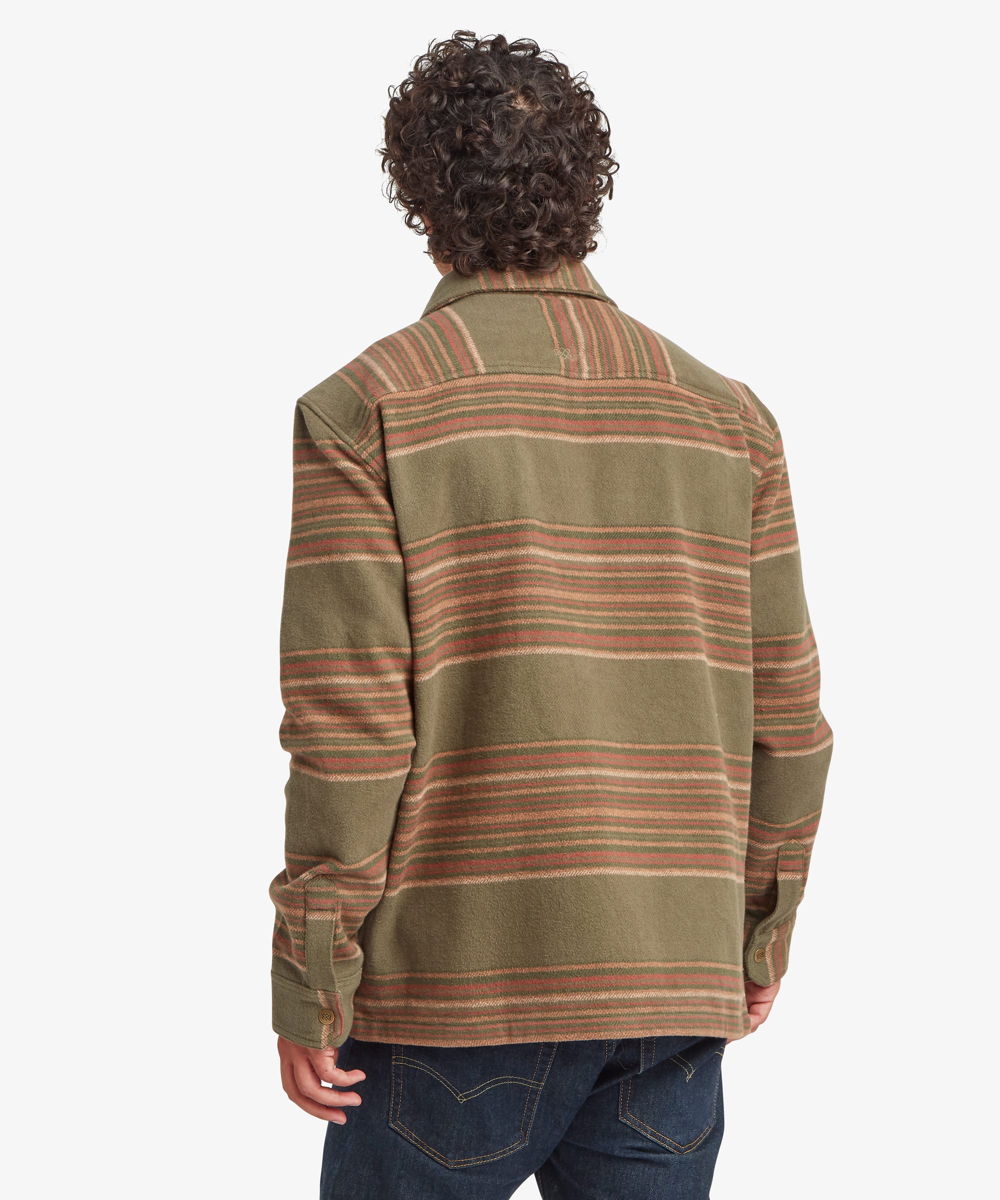 Back view of an olive green shirt jacket featuring horizontal rust and tan stripe patterns across the upper back and sleeves. The relaxed silhouette includes long sleeves and a straight-cut fit designed for layering.