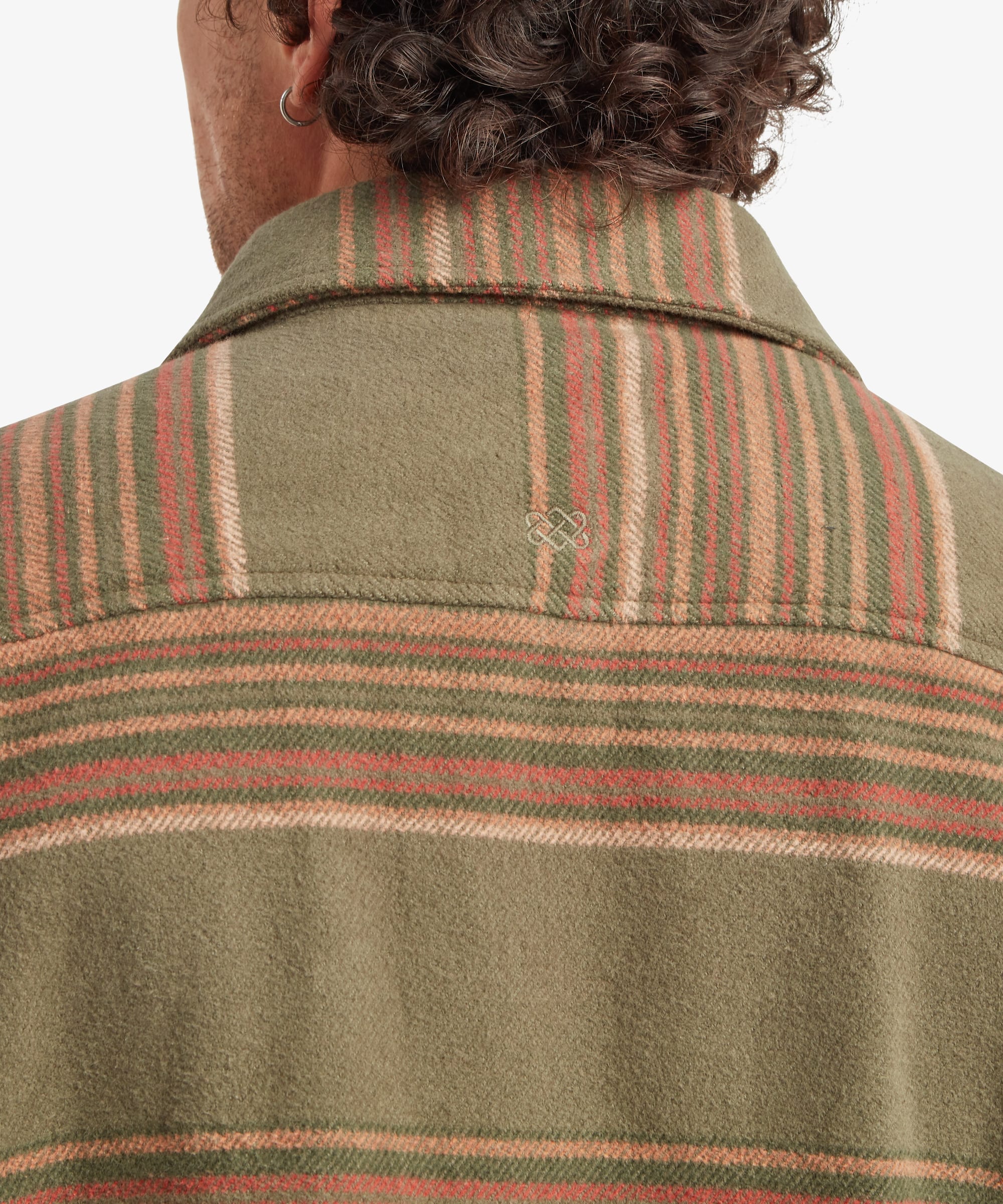 Close-up back view of the shirt jacket collar and upper back. The image highlights the structured collar, back yoke construction and multicoloured horizontal stripe pattern across the shoulders.
