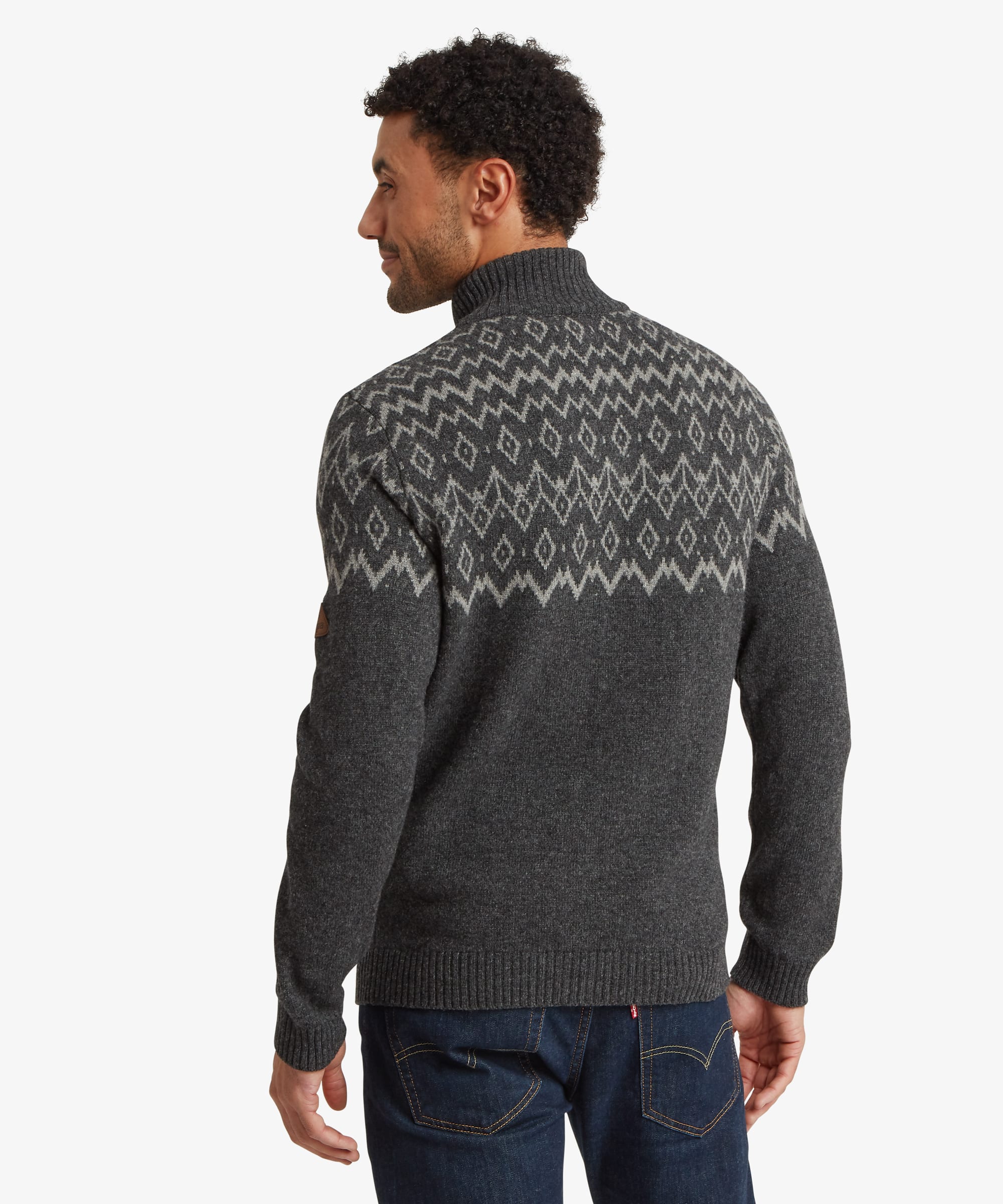 Back view of a charcoal grey quarter-zip sweater featuring an all-around geometric Fair Isle-inspired pattern across the shoulders and upper back. The sweater has a regular fit with ribbed hem and cuffs.