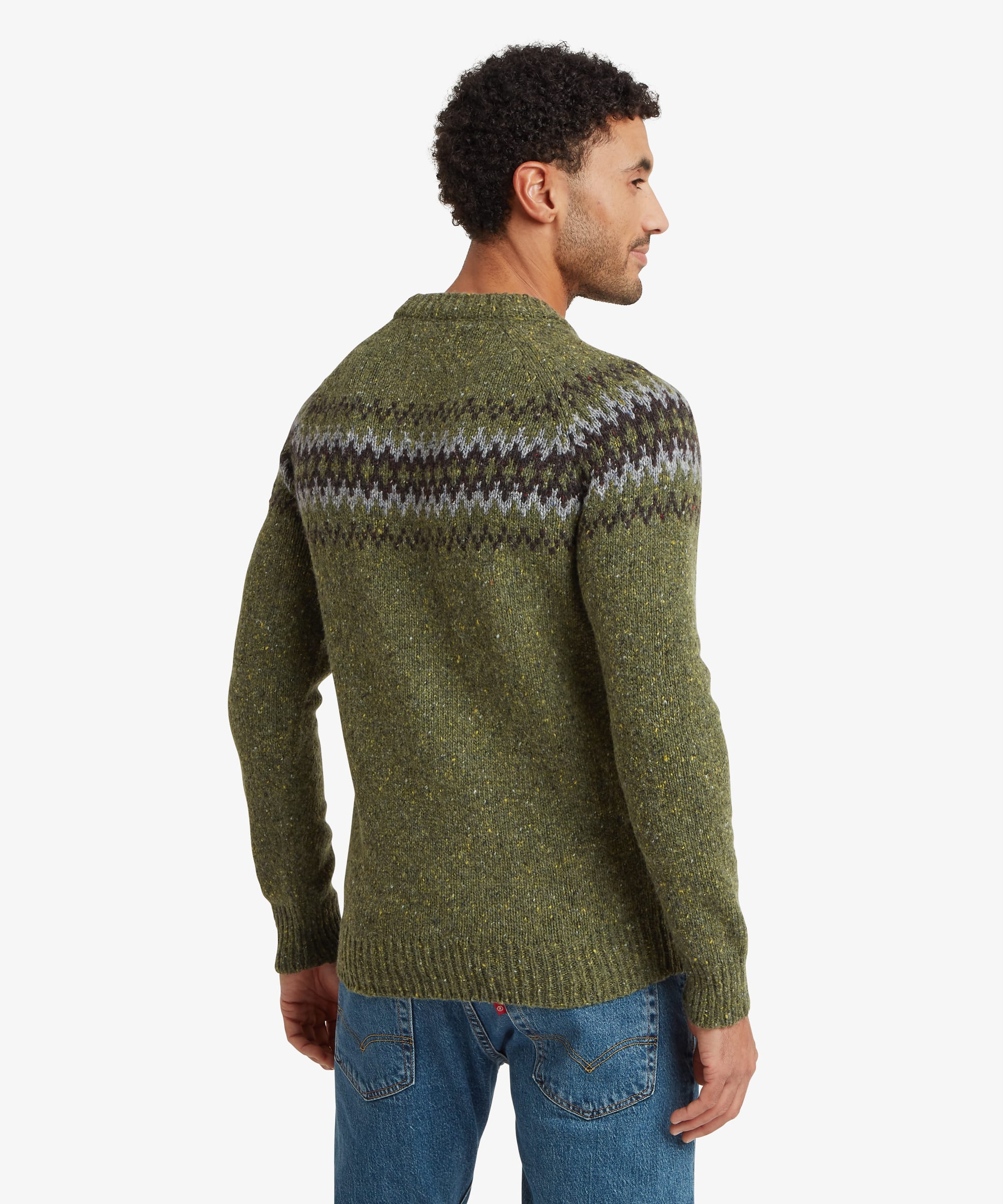 Back view of an olive green crew neck sweater showing the geometric knit pattern continuing across the shoulders and upper back. Styled with blue jeans, the sweater features a regular fit and ribbed finishing.