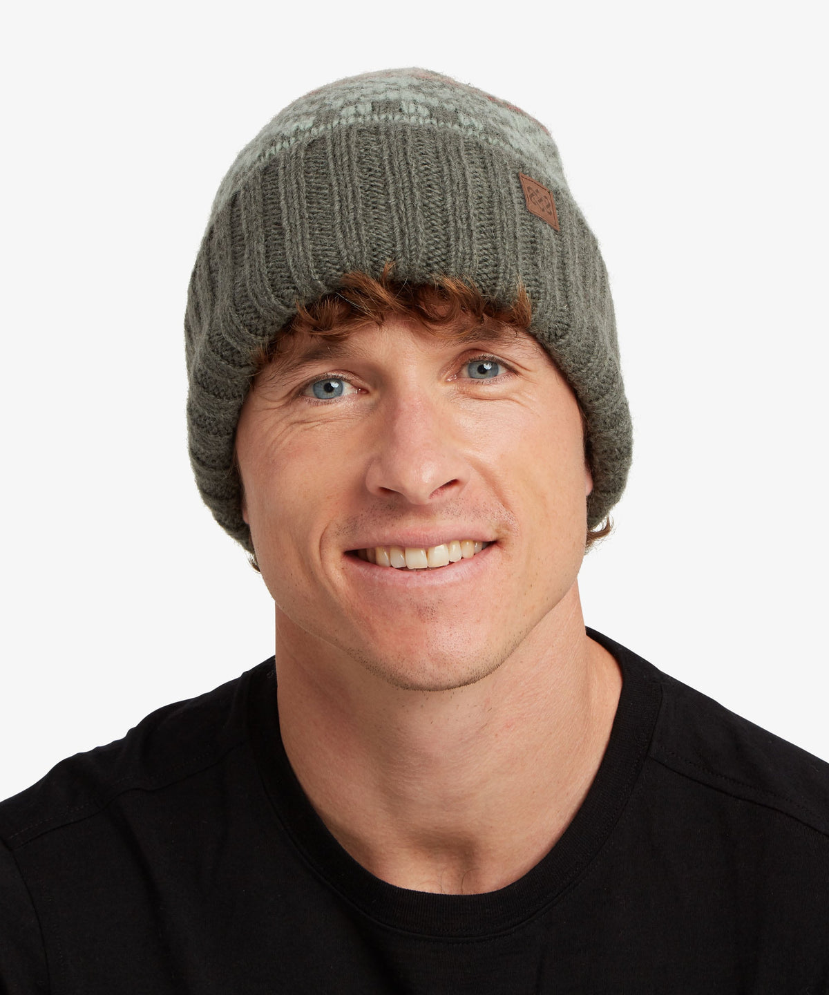 A man in a black T-Shirt wearing a olive knitted hat with a folded up rim.
