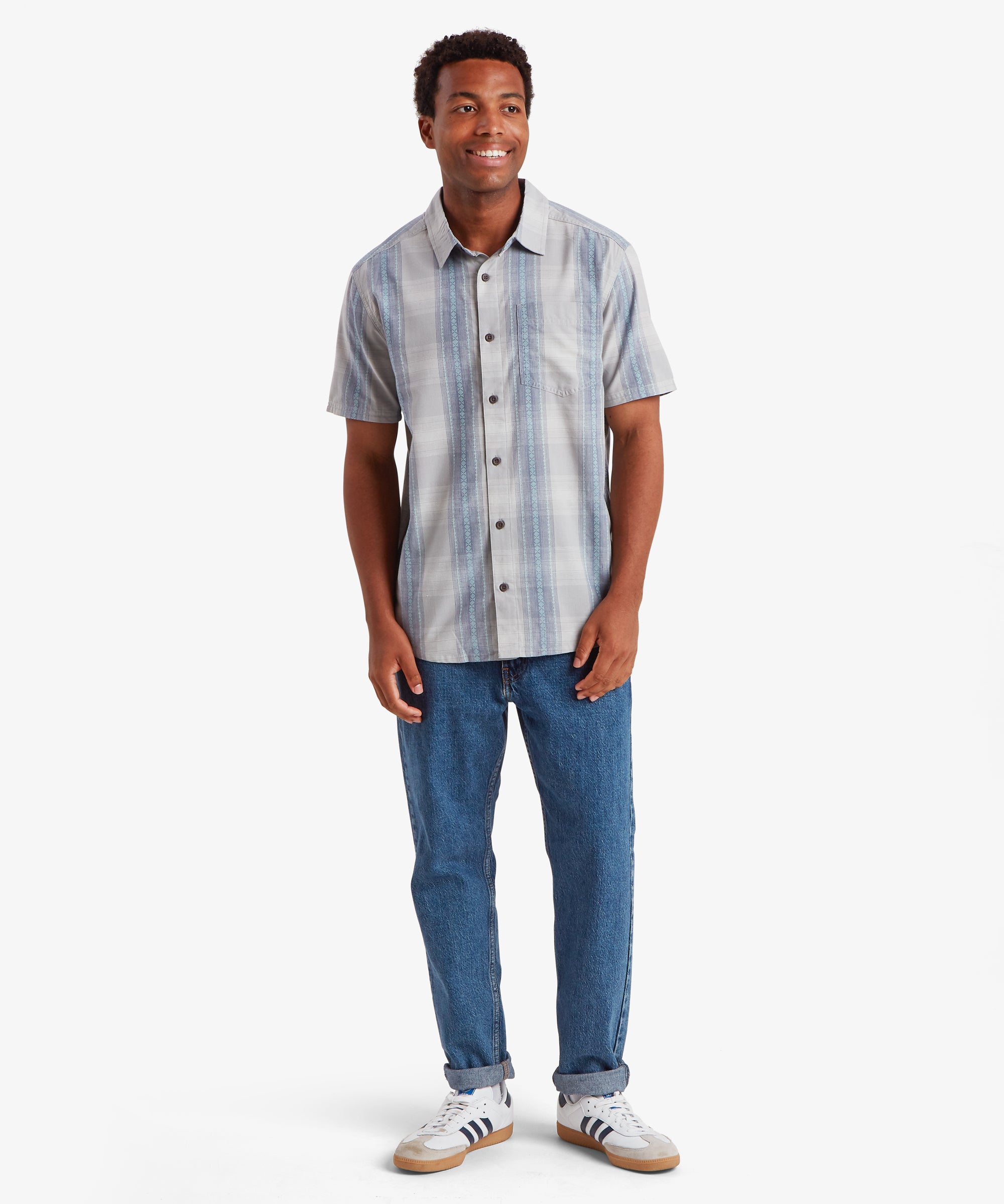Man in Ispat Pearl Blue short sleeve striped shirt and denim jeans