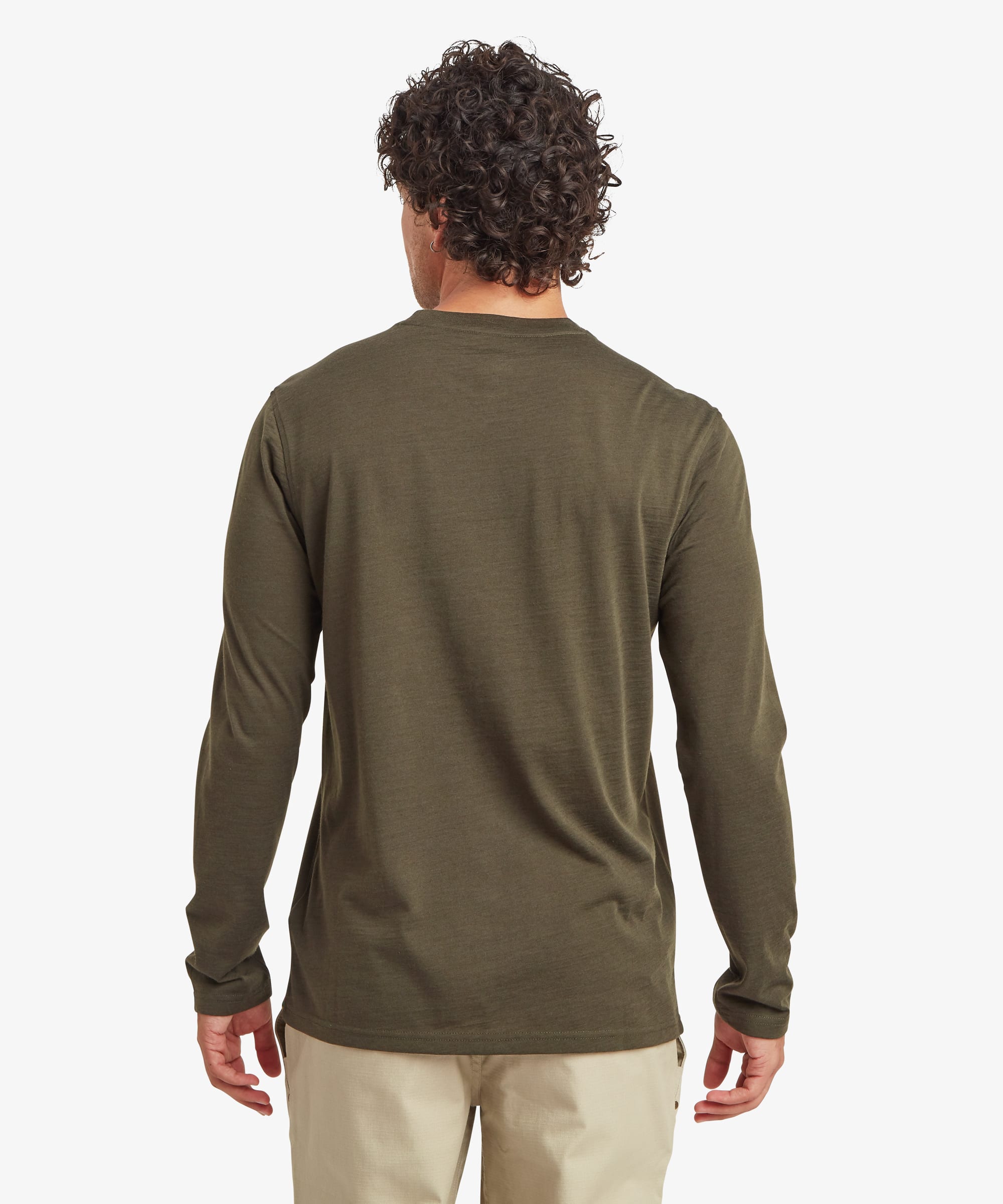 Back view of the olive green long-sleeve merino wool tee, showing the clean construction, straight hem, and relaxed fit across the shoulders. Styled with beige pants.