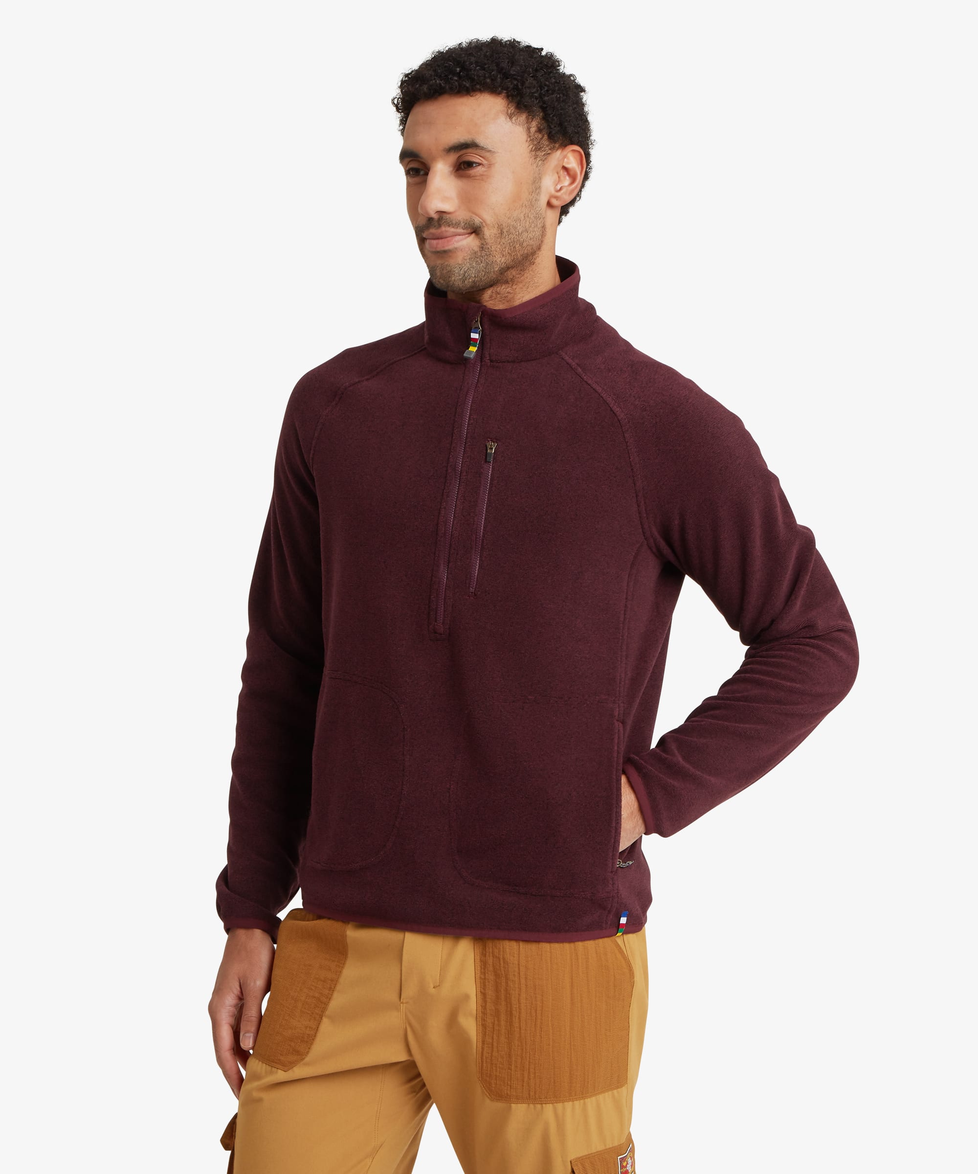 Man wearing a deep burgundy heathered quarter-zip fleece pullover with a stand collar and zippered chest pocket. The regular-fit fleece is paired with tan trousers and offers a relaxed outdoor-inspired look.