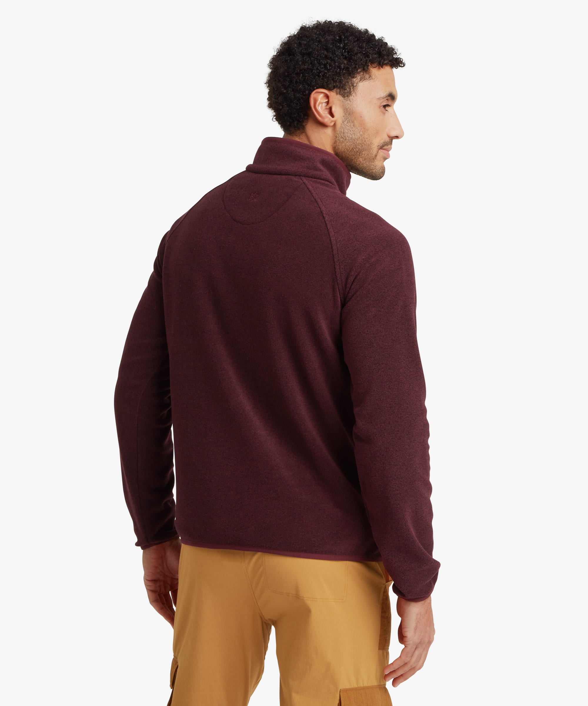 Back view of a burgundy heathered fleece pullover showing the stand collar, raglan sleeve construction and regular-fit shape. Styled with tan trousers.
