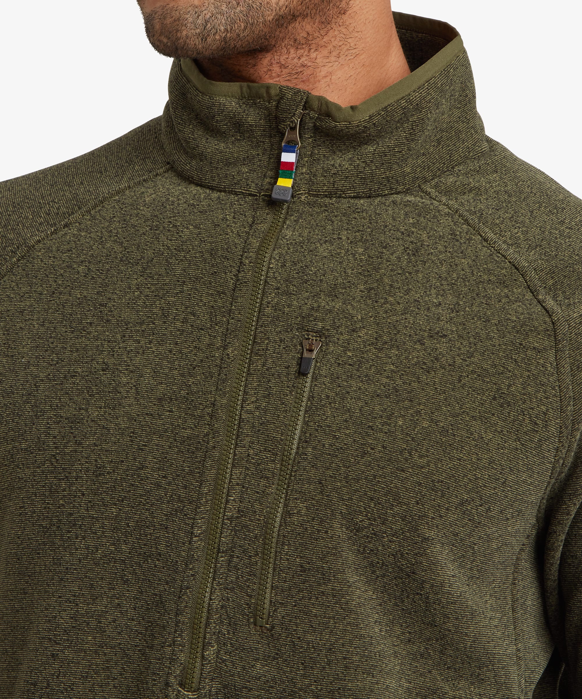 Close-up detail of an olive green fleece featuring the quarter-zip collar, zippered chest pocket and small multicolour trim accents near the zipper.