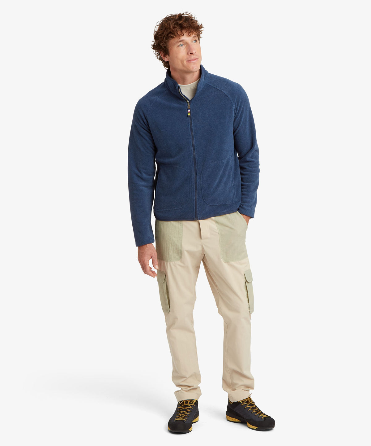 A man modeling a navy blue zip-up fleece jacket.