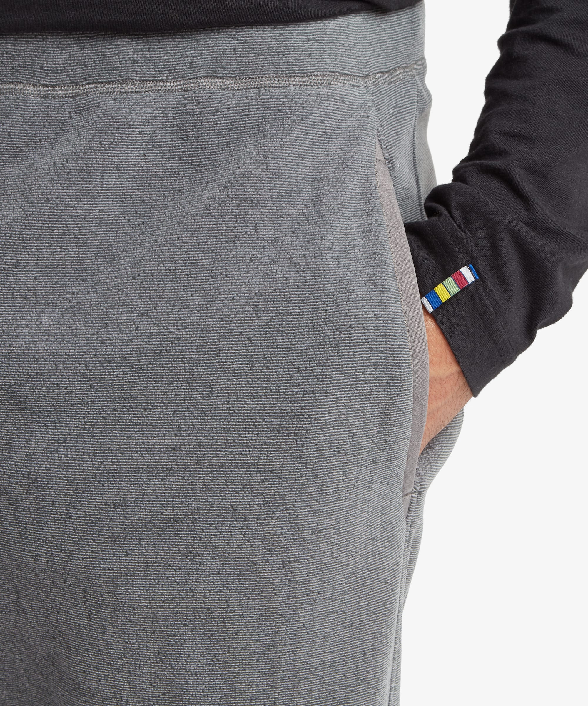 Close-up of the grey jogger waistband featuring adjustable multicolor drawcords, elastic gathering, and soft fleece fabric texture.