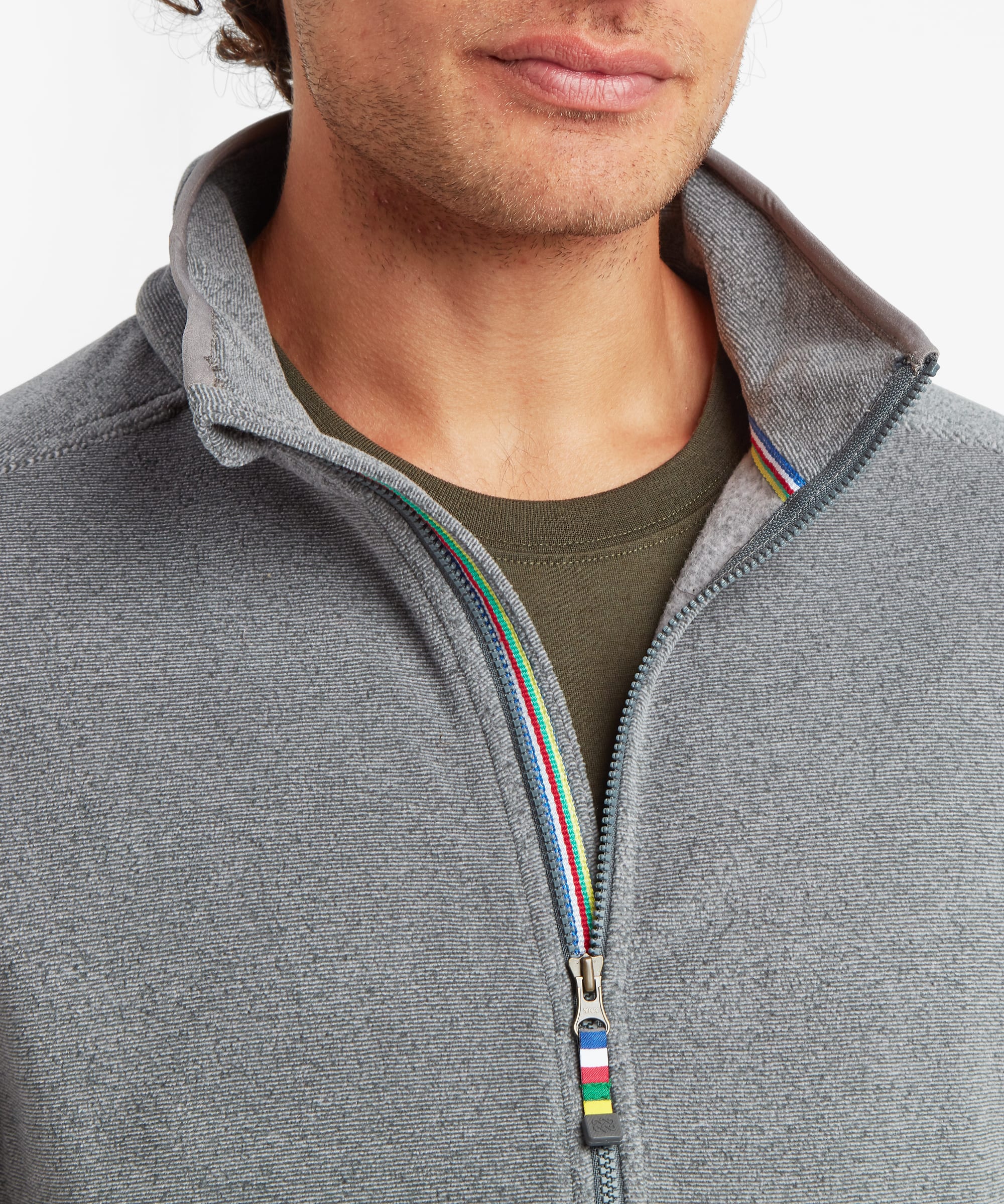Close-up of the grey fleece vest highlighting the stand collar, full-length zipper, soft textured fleece fabric, and signature multicolor trim detail along the zipper placket.