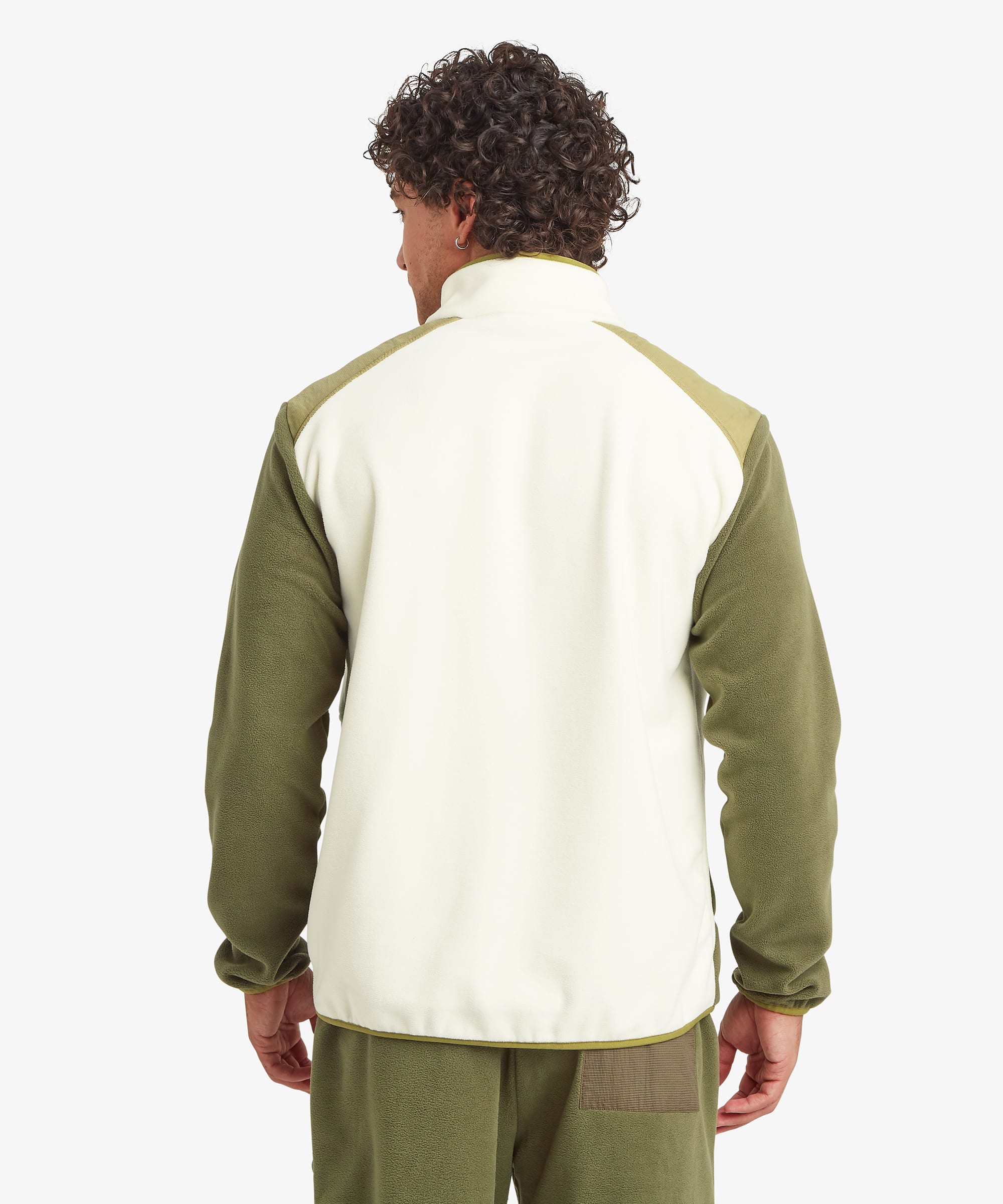 Rear view of a male model wearing the Sherpa Sanu Full Zip in cream with olive sleeves and shoulder panels, displaying the clean back design, stand collar, elasticated hem and relaxed fit.