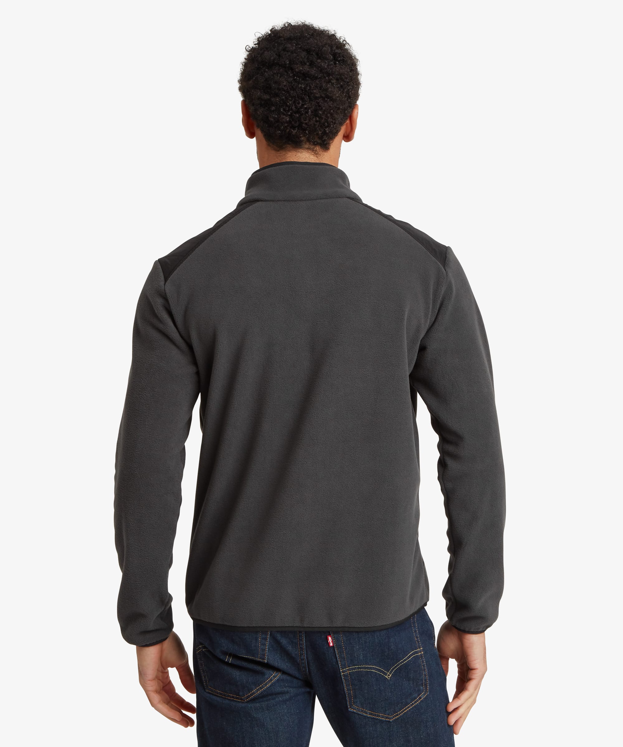 Back view of the black fleece jacket showing the stand collar, clean rear construction, and comfortable fit through the body and sleeves.