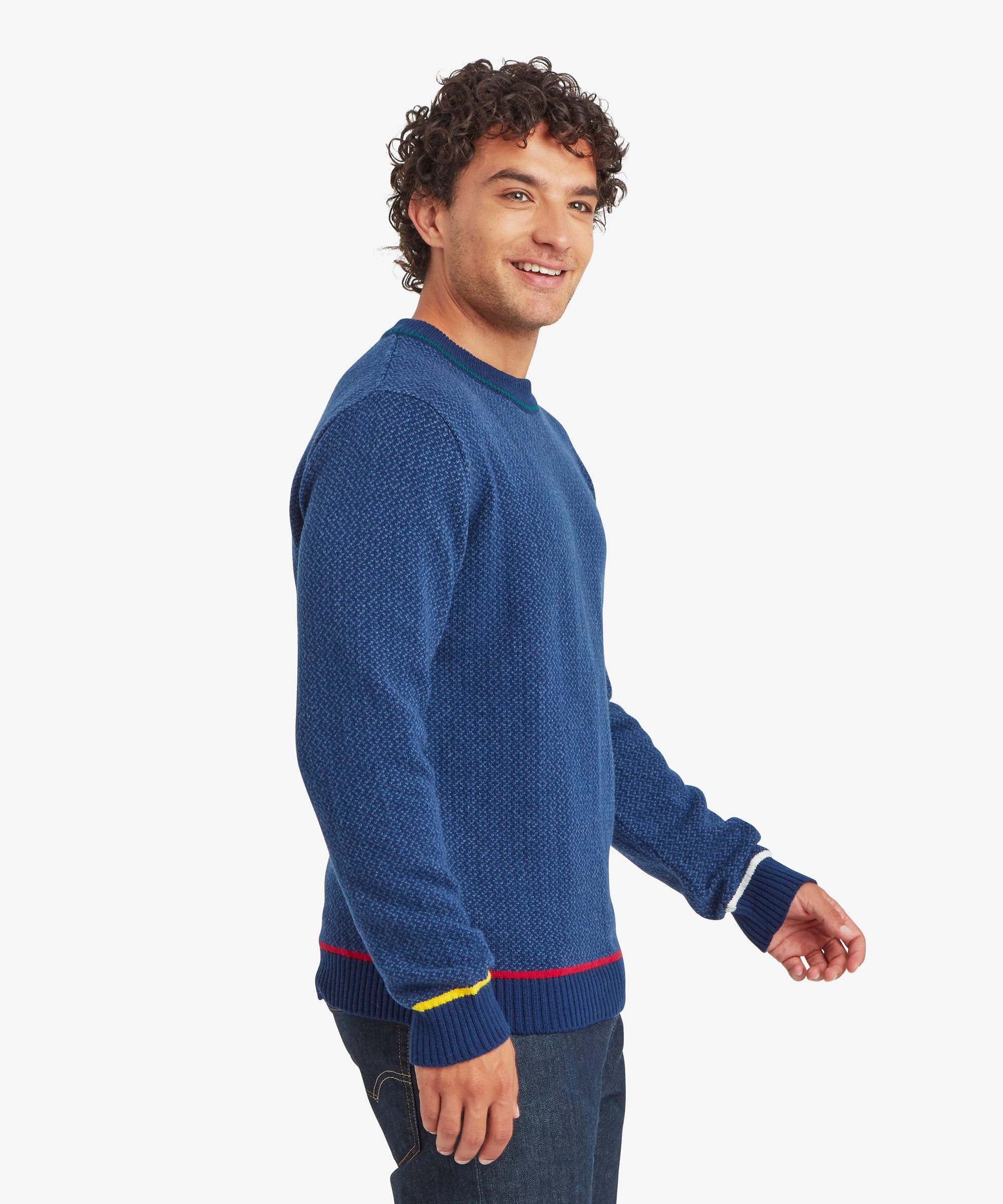Side profile of a blue textured knit sweater highlighting the relaxed fit, ribbed cuffs, and contrast trim accents.