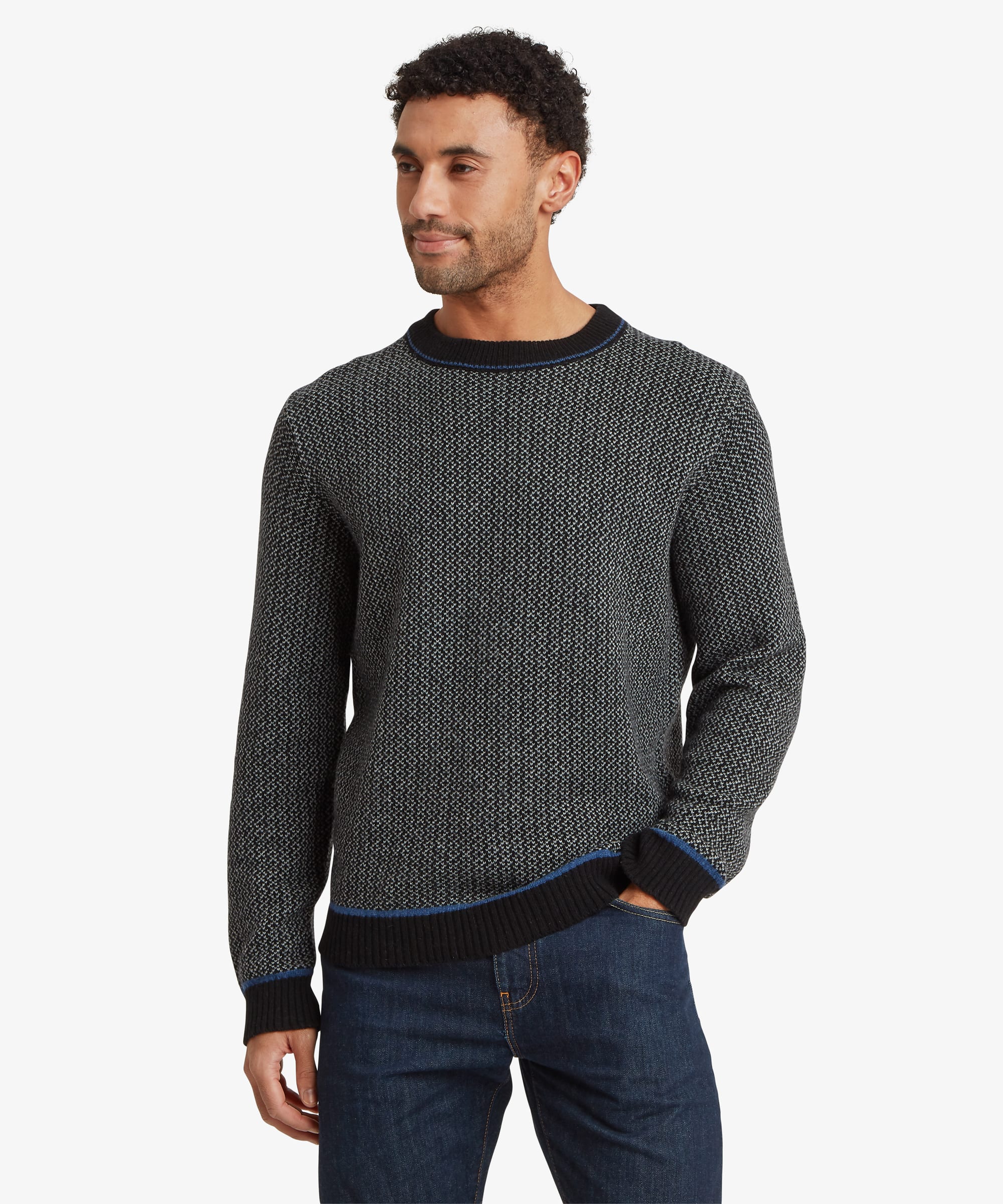 Front view of a dark grey crew neck sweater featuring an all-over textured knit pattern, ribbed neckline, cuffs and hem, and a small woven logo tab near the hem.