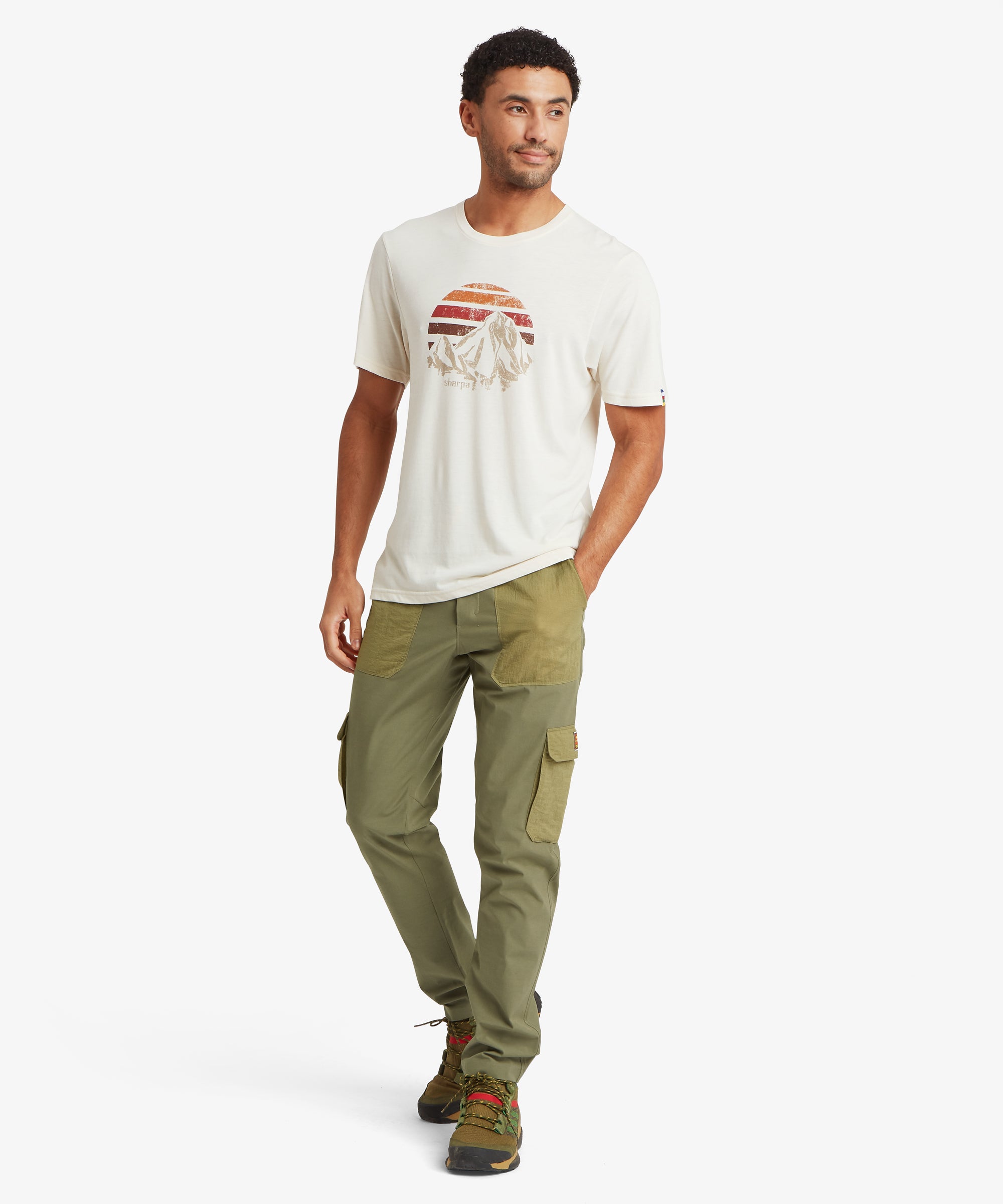 Front view of olive outdoor pants with contrast ripstop patch pockets and a yellow drawcord waist, styled for lightweight movement and hiking comfort.