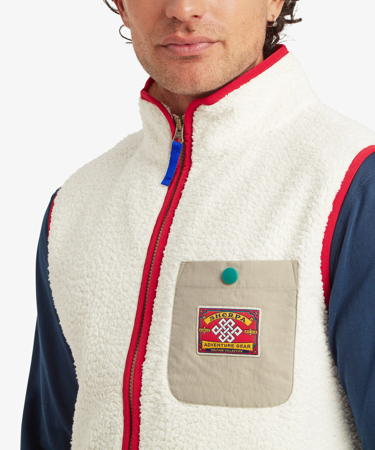 Close-up of a male model wearing the Sherpa Tarcho Vest in white textured fleece.