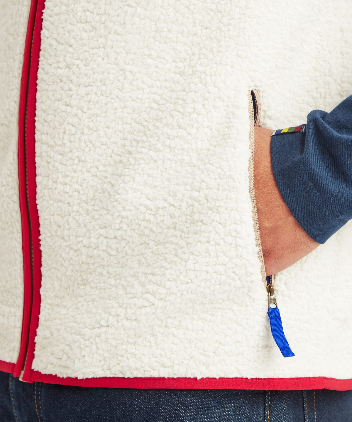 Close-up detail of the Sherpa Tarcho Vest in white fleece showing the textured fabric.