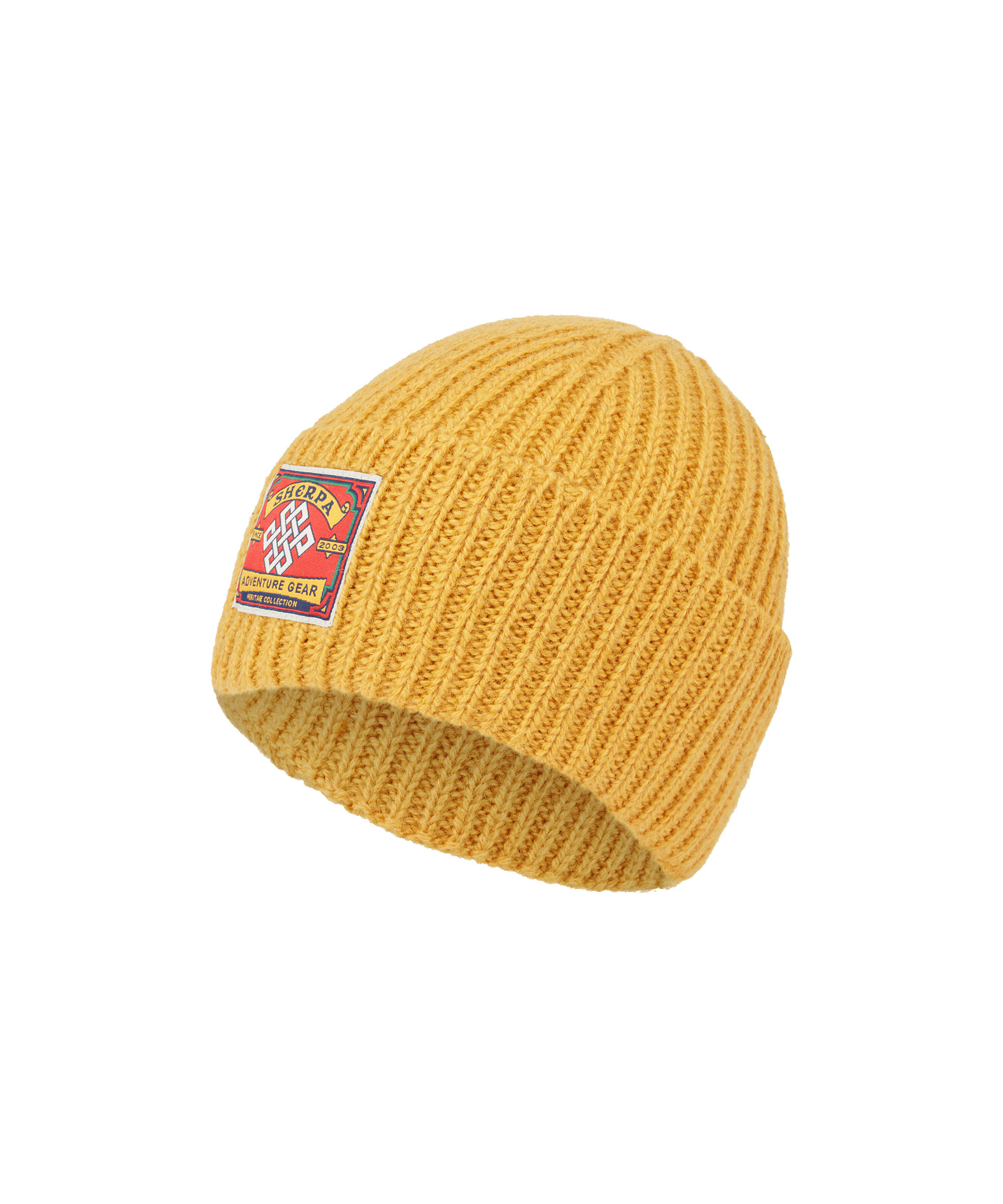 Front view of a Sherpa Adventure Gear unisex rib-knit beanie in mustard yellow. Features a folded cuff, chunky knit construction, signature logo patch, and classic outdoor-inspired style.