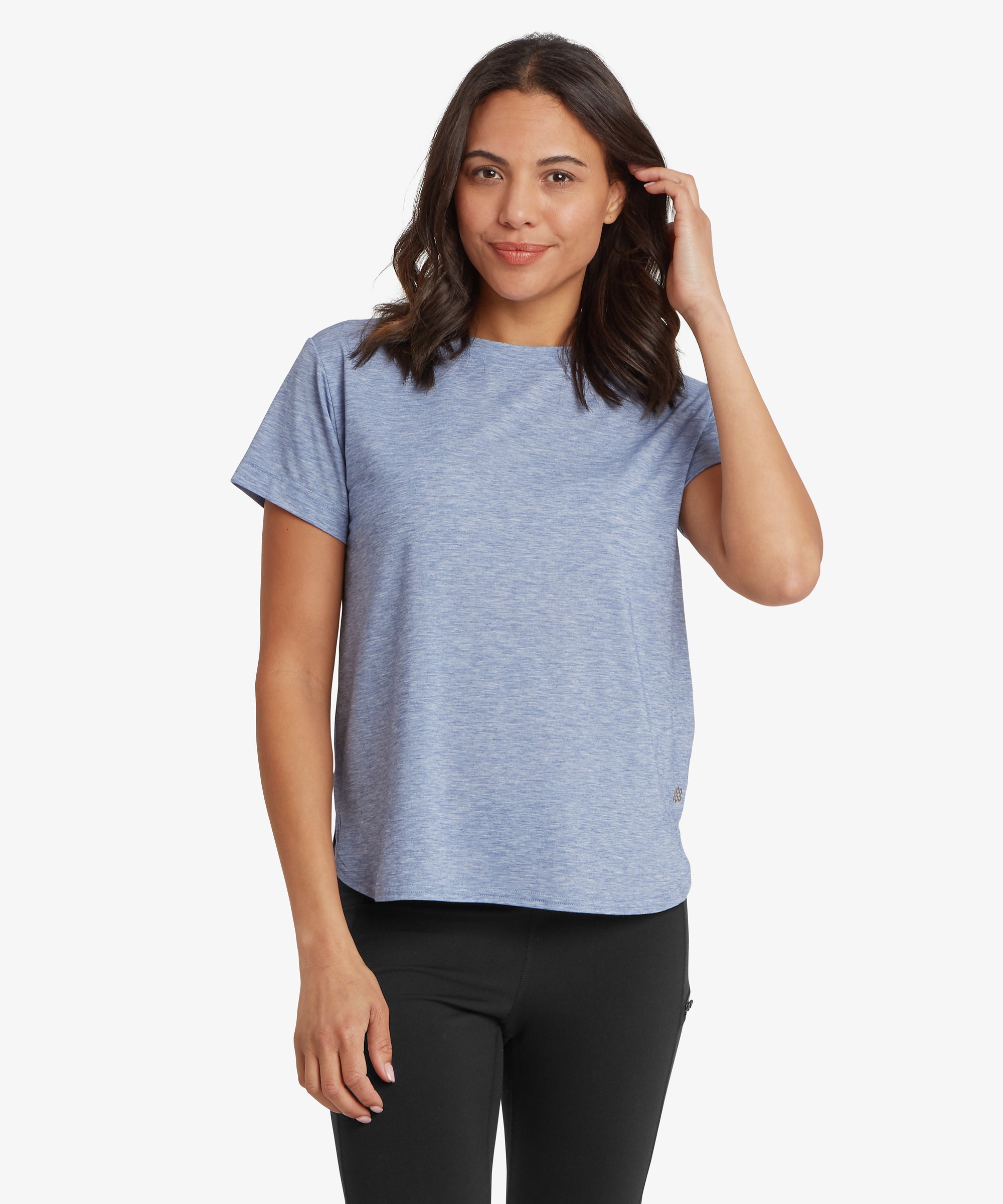 Front view of a person wearing a blue patterned crew‑neck top paired with dark trousers. The image highlights the fit of the top, including the neckline, sleeve length, and overall silhouette.