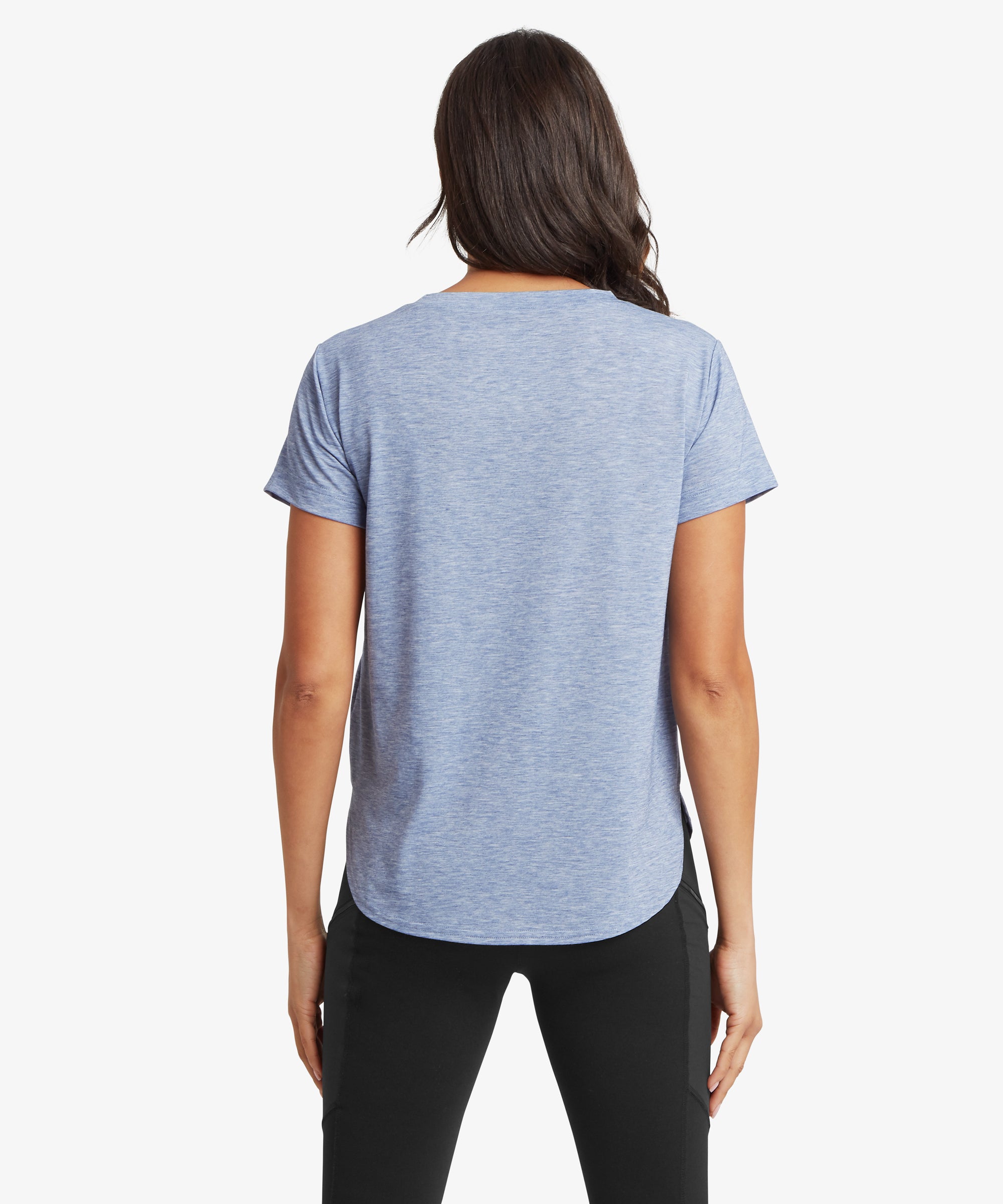 Rear view of a blue patterned long‑sleeve crew‑neck top paired with dark leggings.
