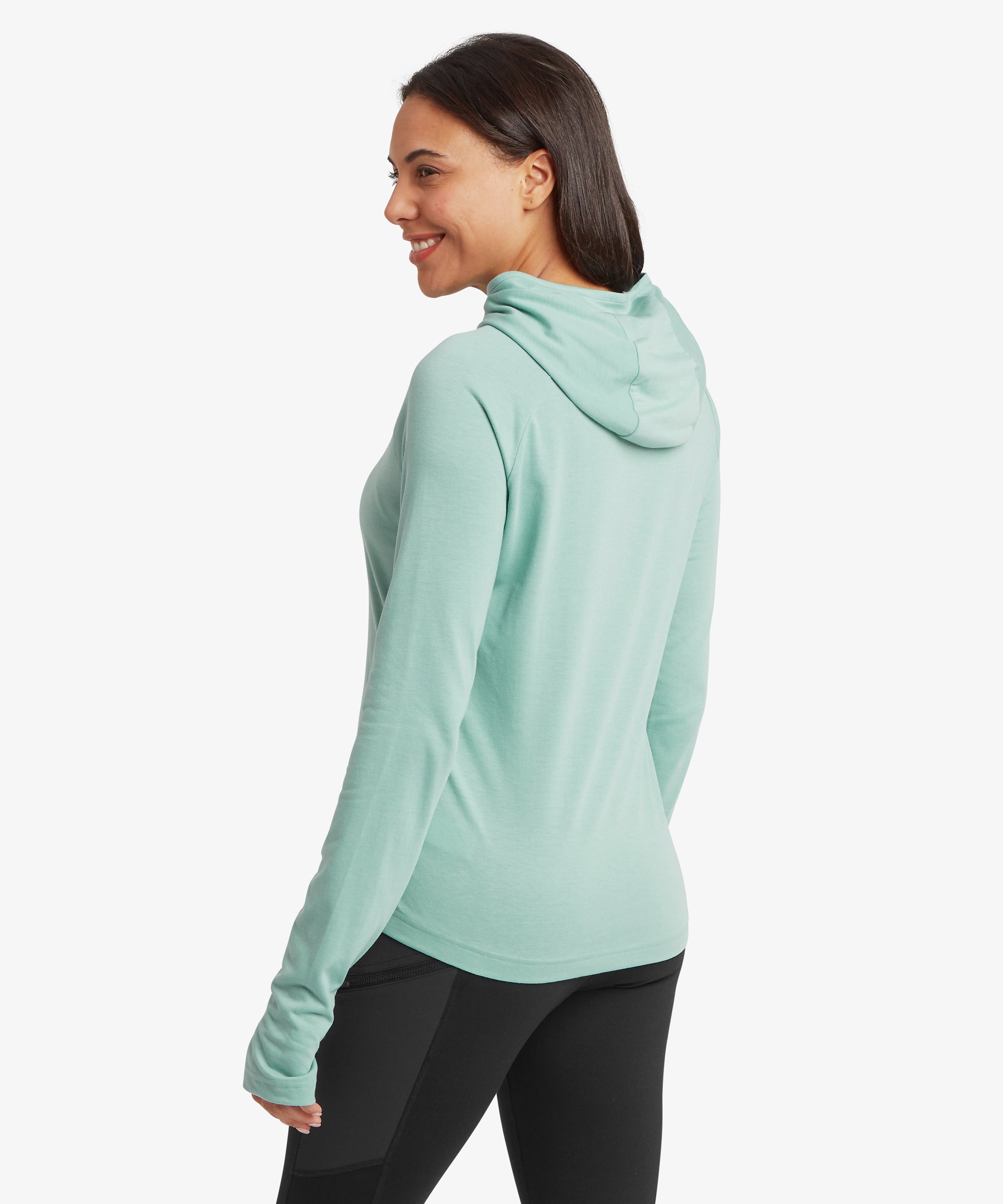 Woman wearing a light blue hoodie and black leggings on a white background
