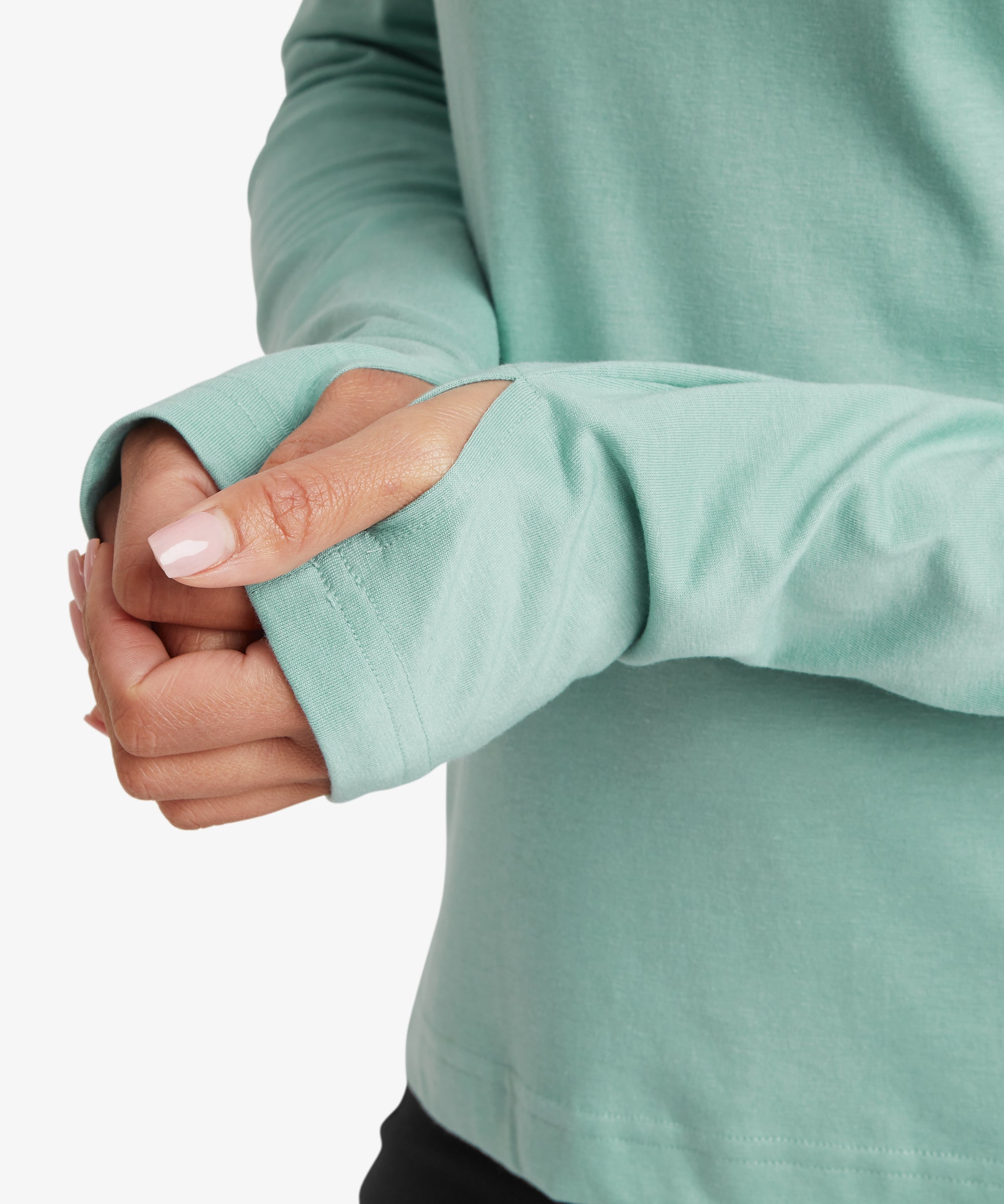 Close-up of the light aqua performance hoodie sleeve showing the extended cuff with integrated thumbhole, highlighting functional design for warmth, layering, and active outdoor use.