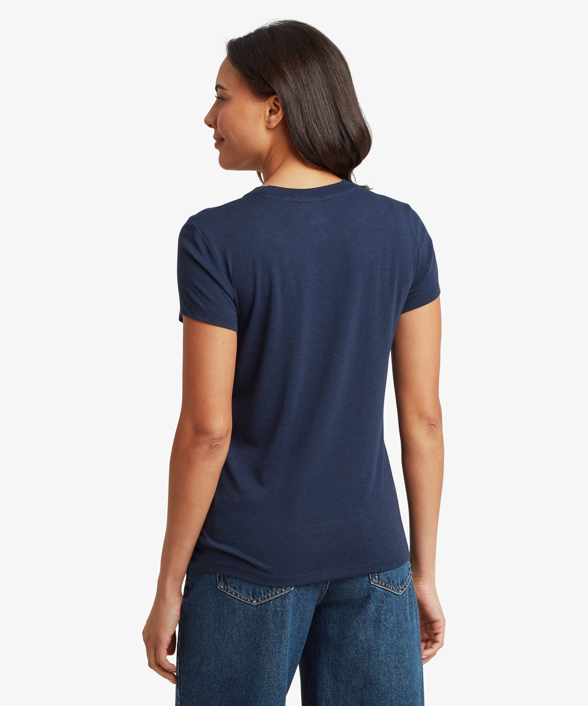 Back view of a navy blue women’s short‑sleeve T‑shirt paired with mid‑wash denim jeans. The T‑shirt features a classic crew neckline, smooth lightweight fabric, and a relaxed, comfortable fit that falls to the hip. The image highlights the clean, simple back design, natural drape of the material, and overall silhouette of the casual everyday tee.