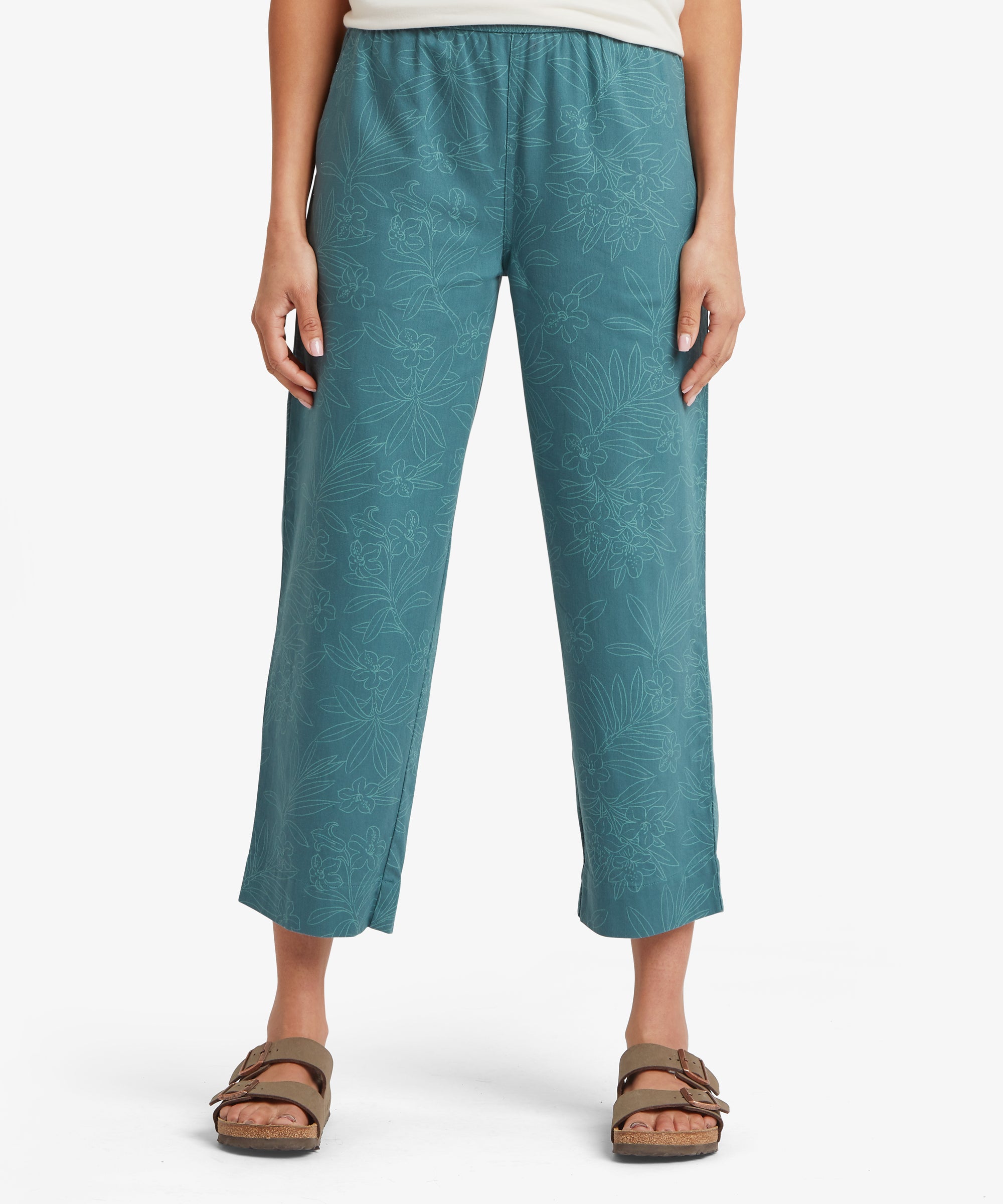 Front view of a woman wearing teal cropped trousers showing a straight-leg silhouette, mid-rise waist, and relaxed fit through the hip and thigh.