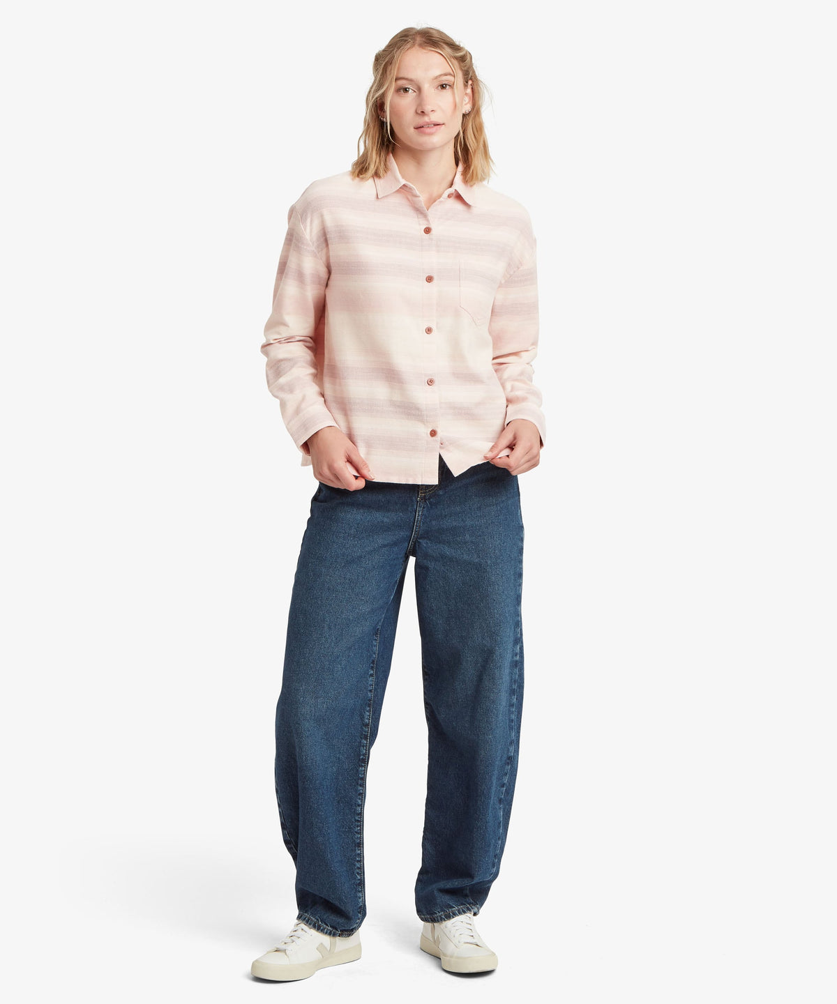 Woman wearing Sherpa Adventure Gear Beeja Long Sleeve Shirt in beige.