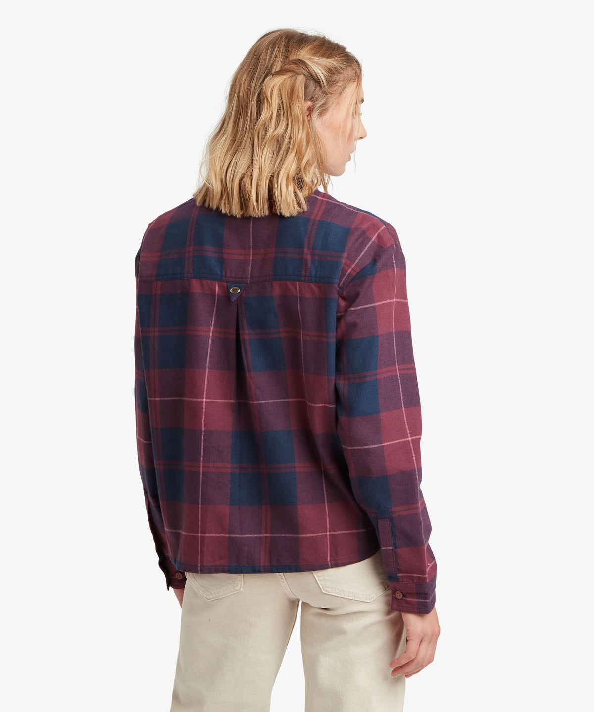 Rear view of woman wearing Sherpa Adventure Gear Beeja Long Sleeve Shirt in purple and navy check.