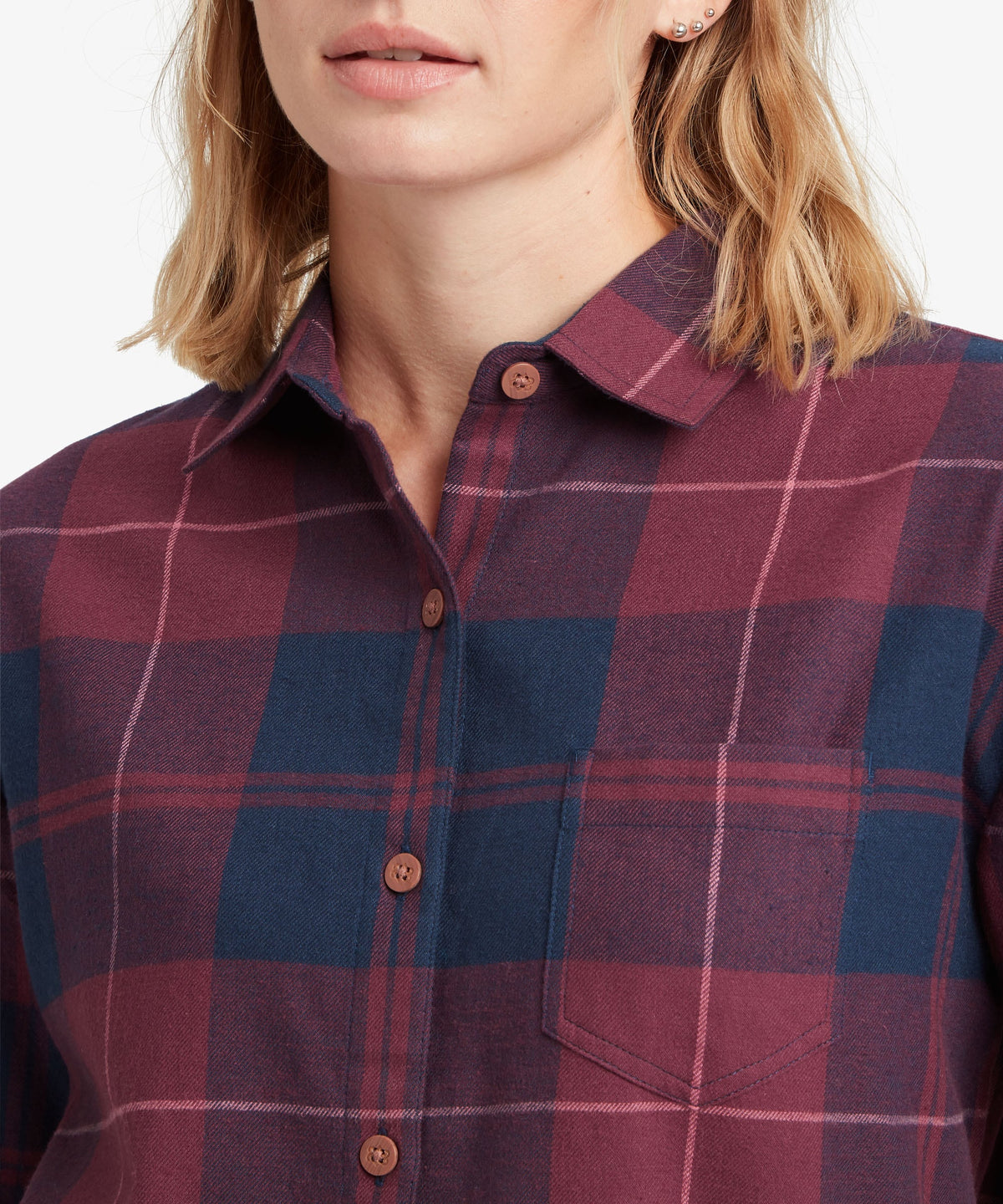 A female model wearing the Sherpa Adventure Gear Beeja Long Sleeve Shirt in purple and navy check.