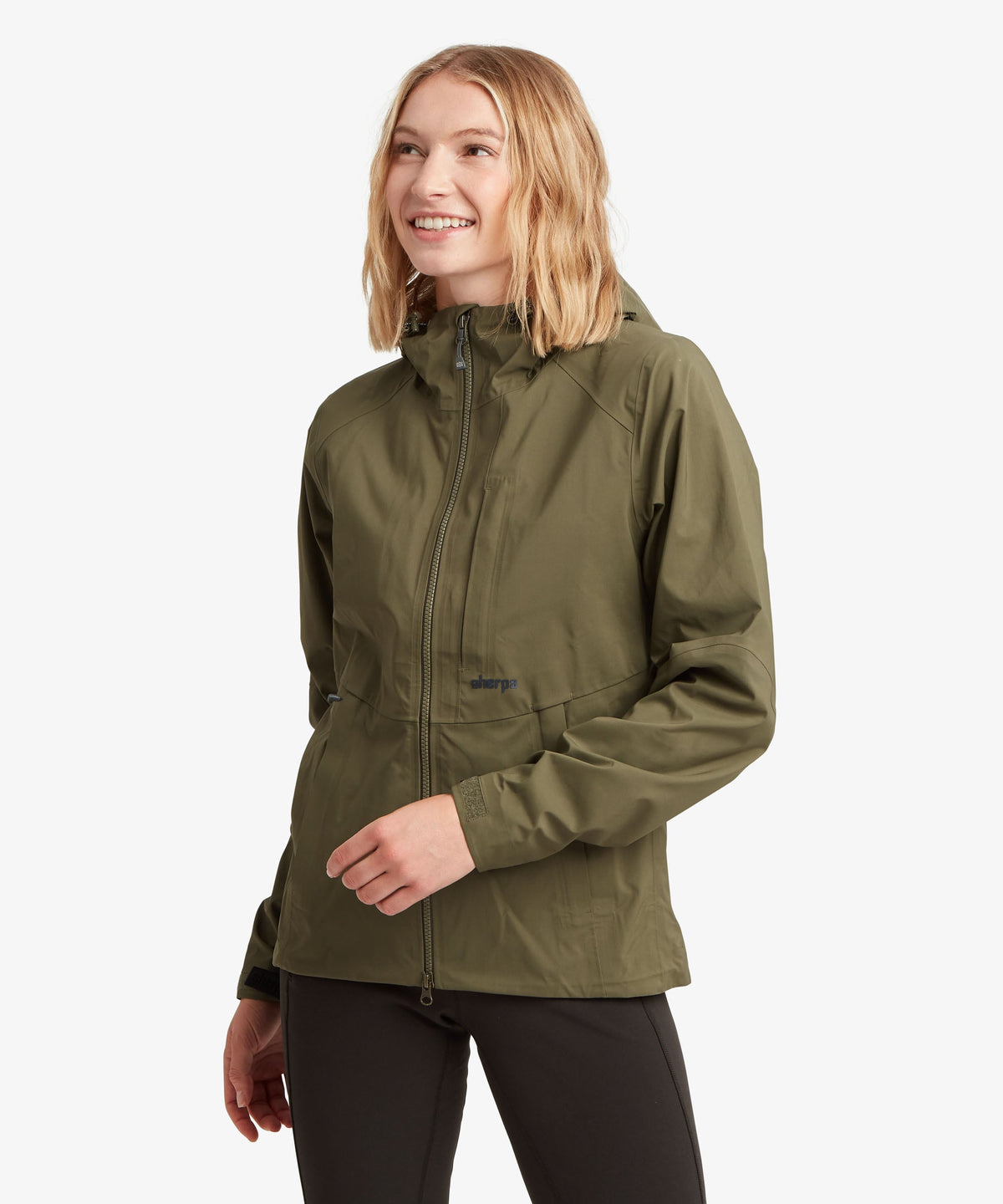 Woman wearing Sherpa Adventure Gear Beyul 3L Jacket in green.